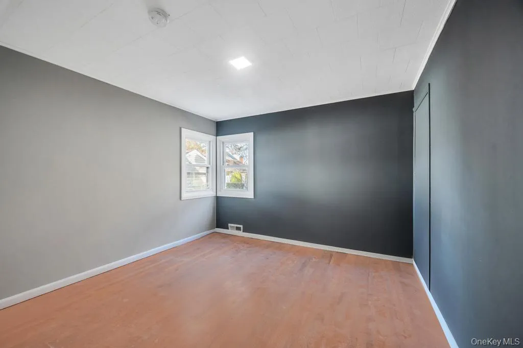 Spare room featuring light wood-type flooring and baseboards Spare room featuring light wood-type flooring and baseboards