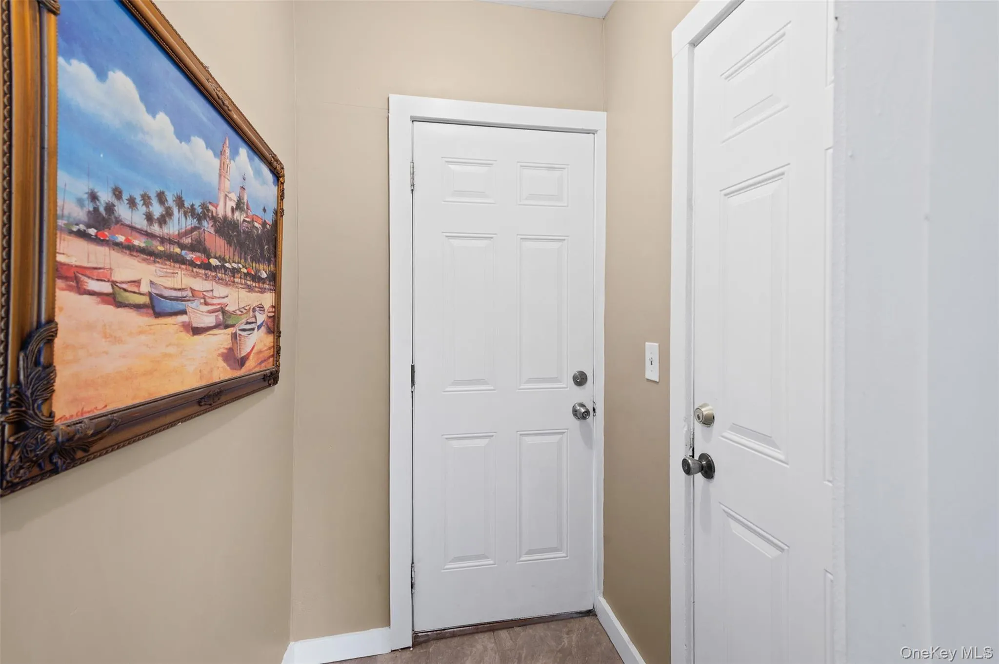Doorway to outside featuring baseboards Doorway to outside featuring baseboards