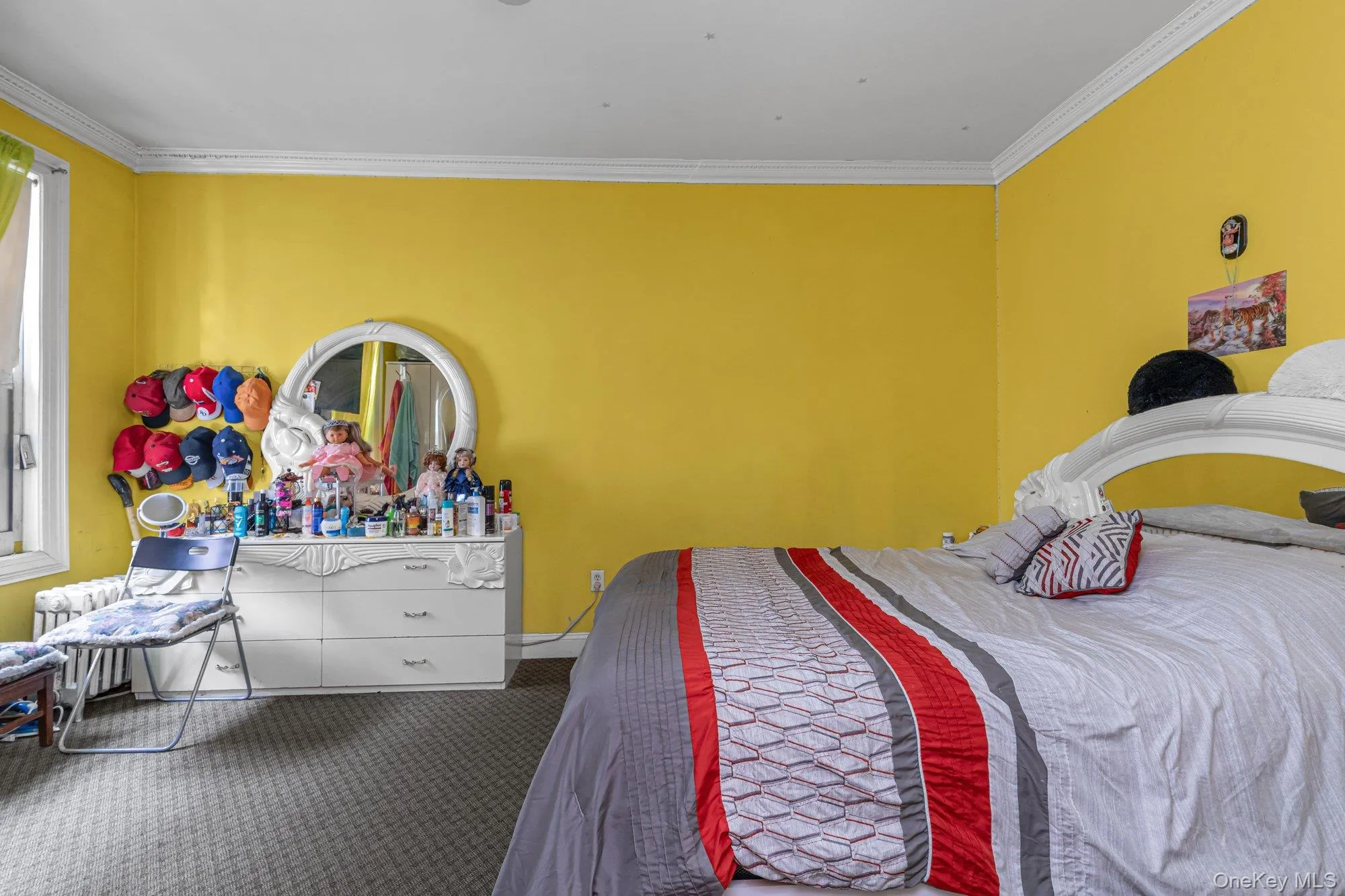Carpeted bedroom featuring crown molding and radiator Carpeted bedroom featuring crown molding and radiator