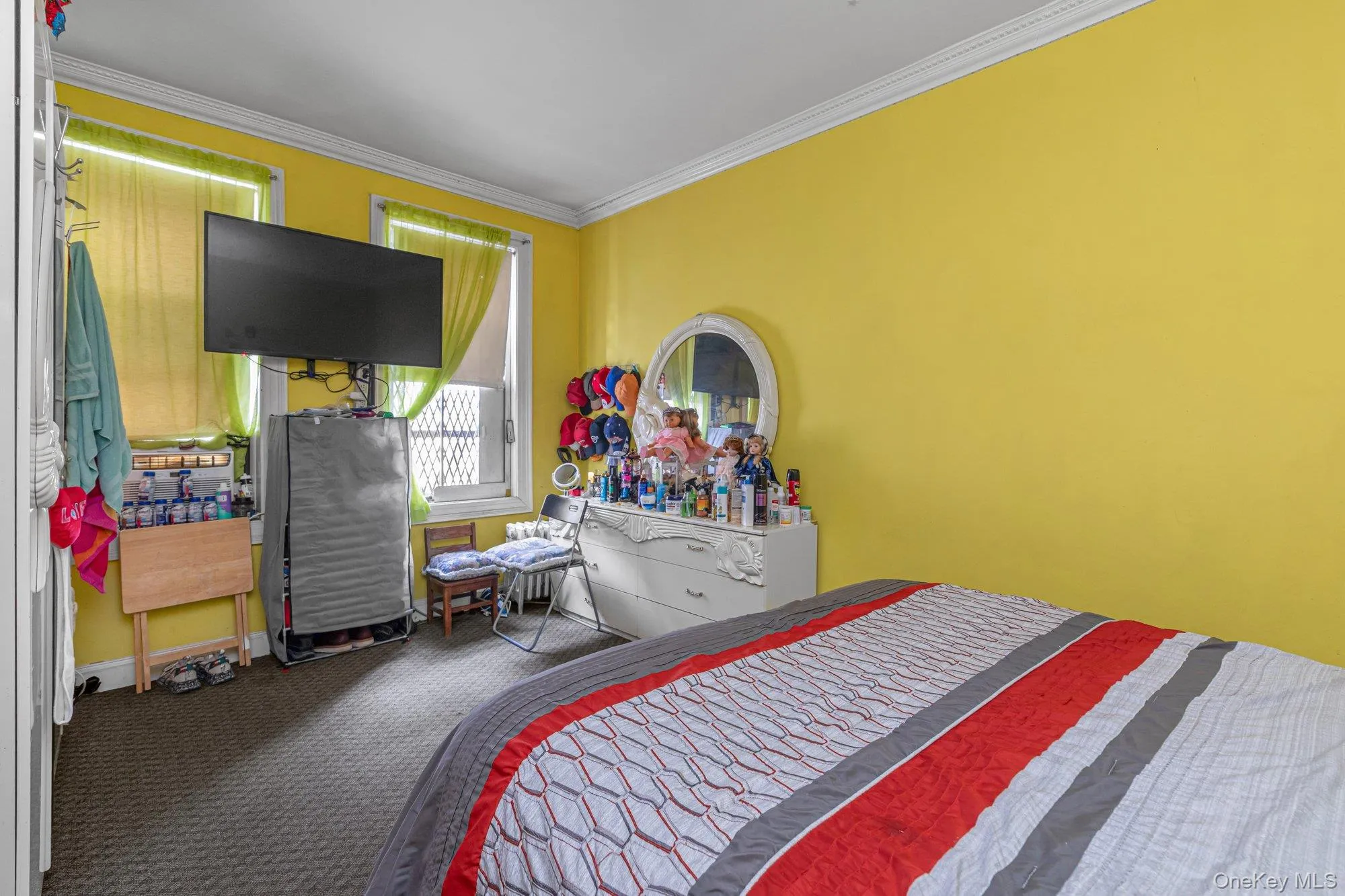 Bedroom featuring crown molding and carpet flooring Bedroom featuring crown molding and carpet flooring