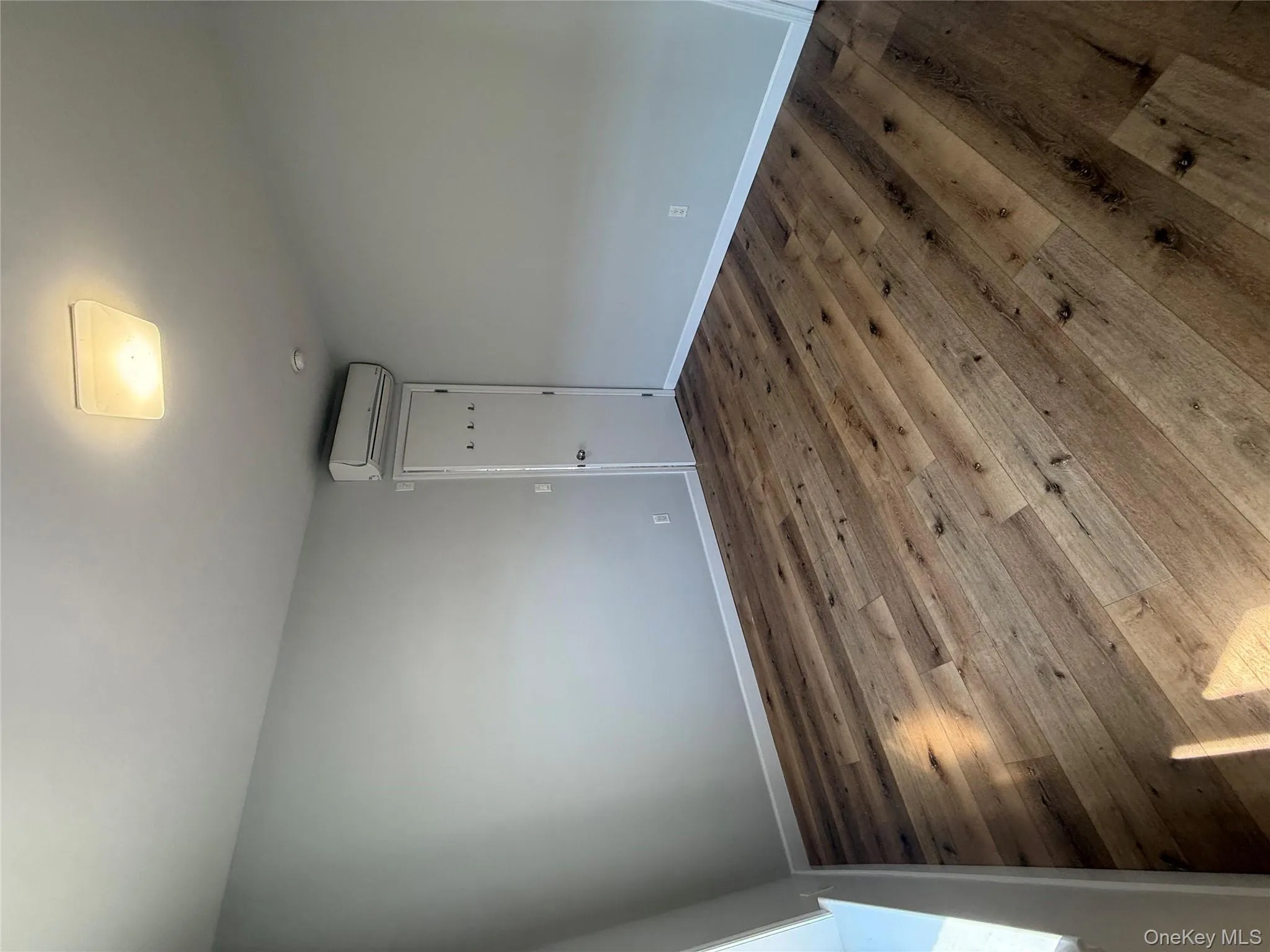 Spare room with wood-type flooring Spare room with wood-type flooring