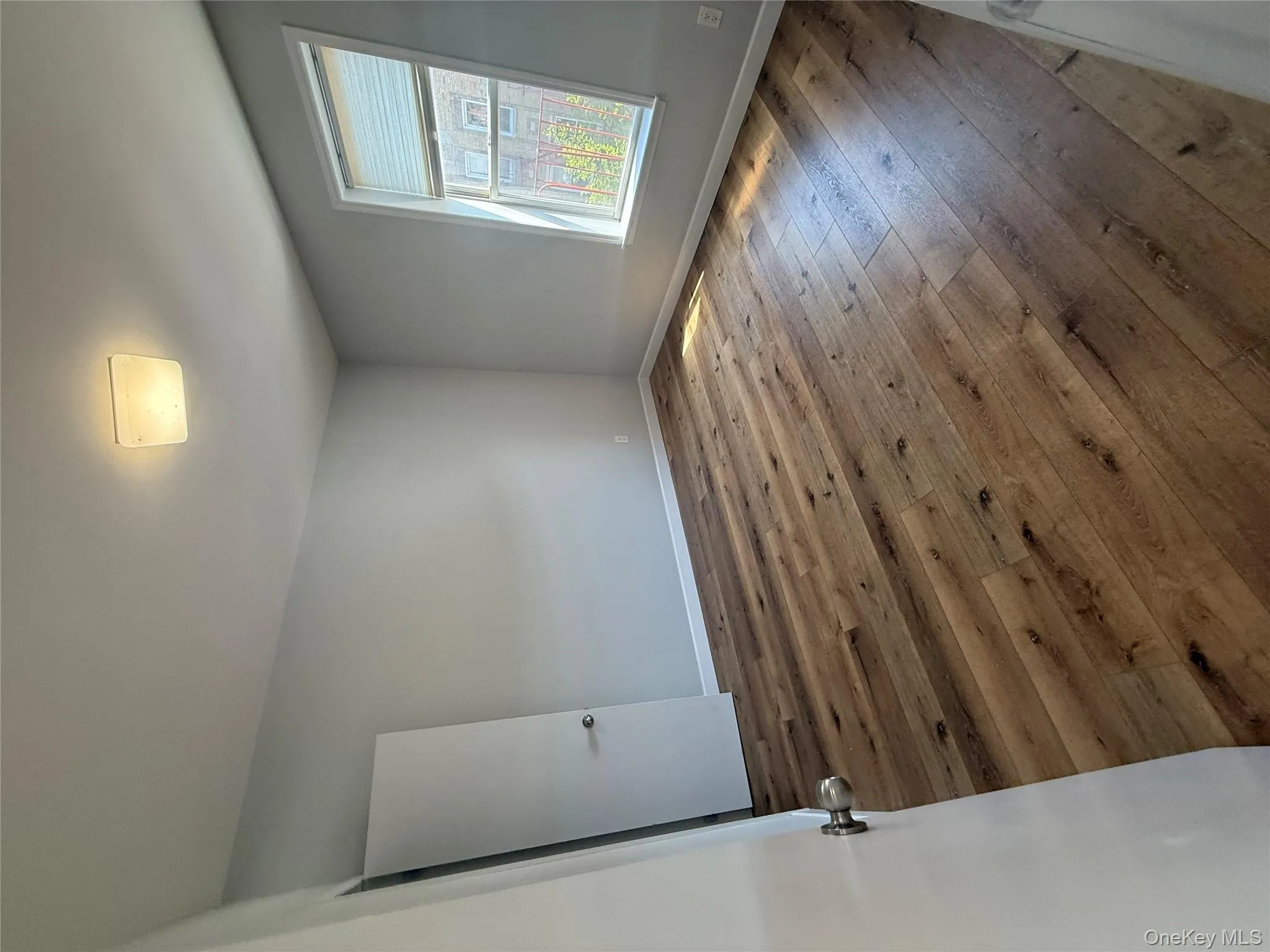 Empty room with baseboards and wood-type flooring Empty room with baseboards and wood-type flooring