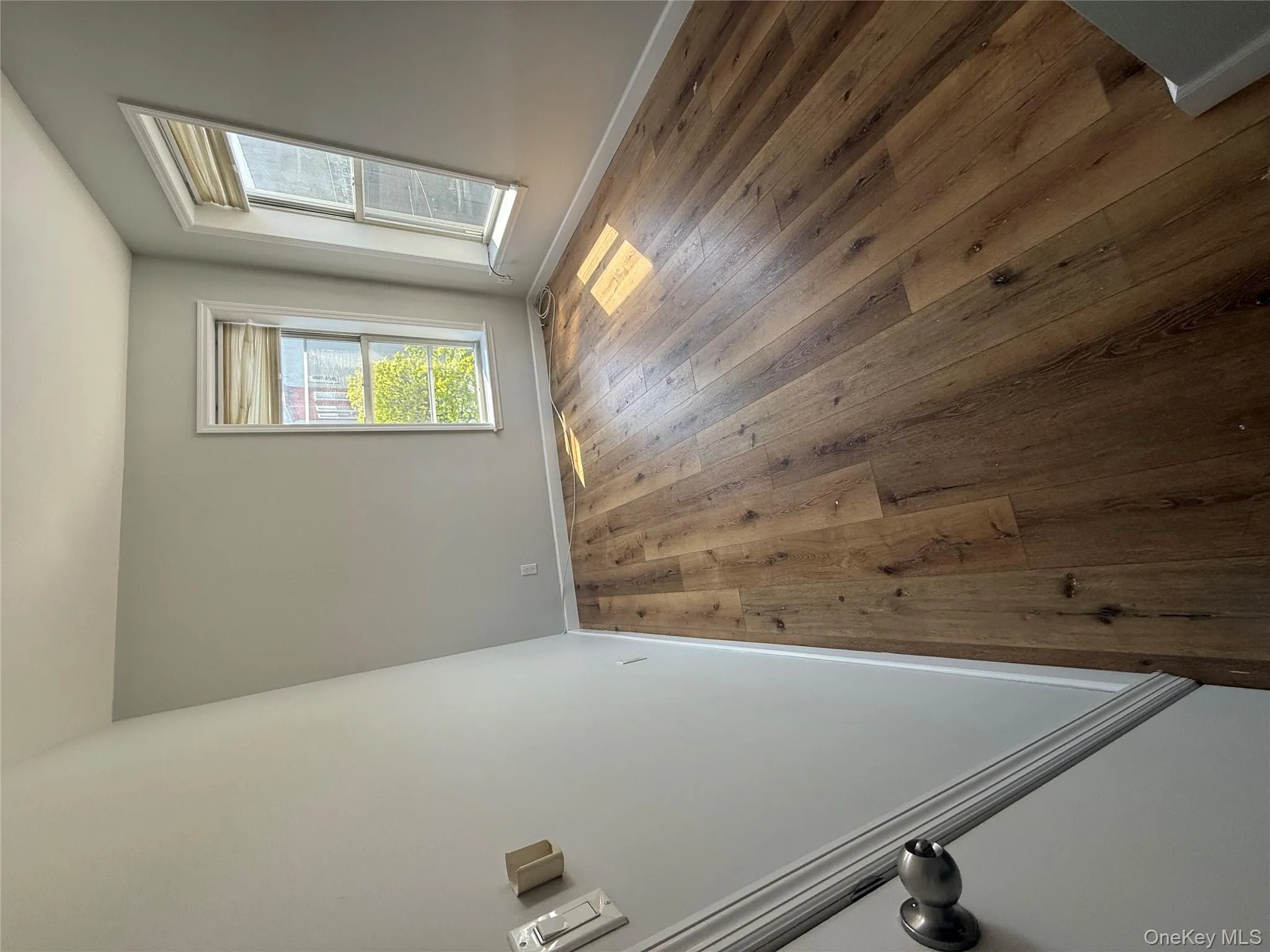 Unfurnished room featuring hardwood / wood-style flooring and baseboards Unfurnished room featuring hardwood / wood-style flooring and baseboards