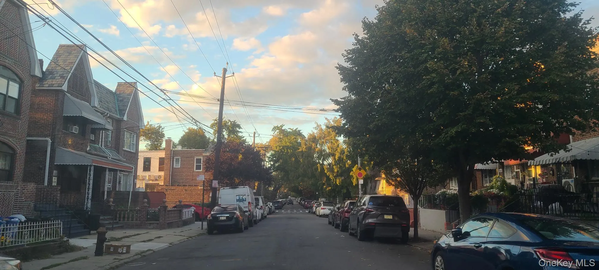 View of asphalt road featuring sidewalks, traffic signs, and curbs View of asphalt road featuring sidewalks, traffic signs, and curbs