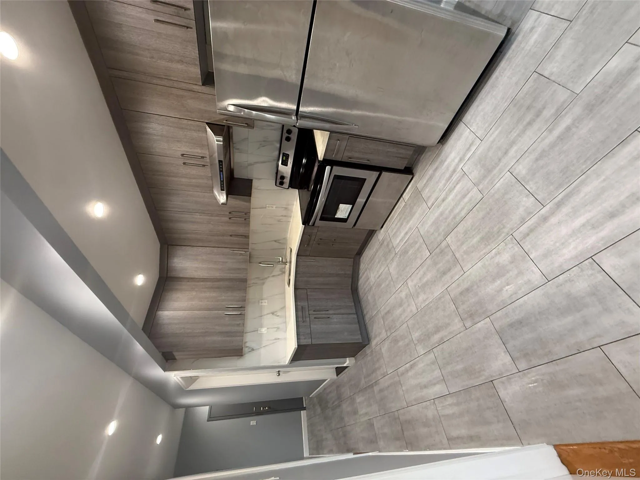 Kitchen featuring refrigerator, decorative backsplash, stainless steel range, recessed lighting, and extractor fan Kitchen featuring refrigerator, decorative backsplash, stainless steel range, recessed lighting, and extractor fan