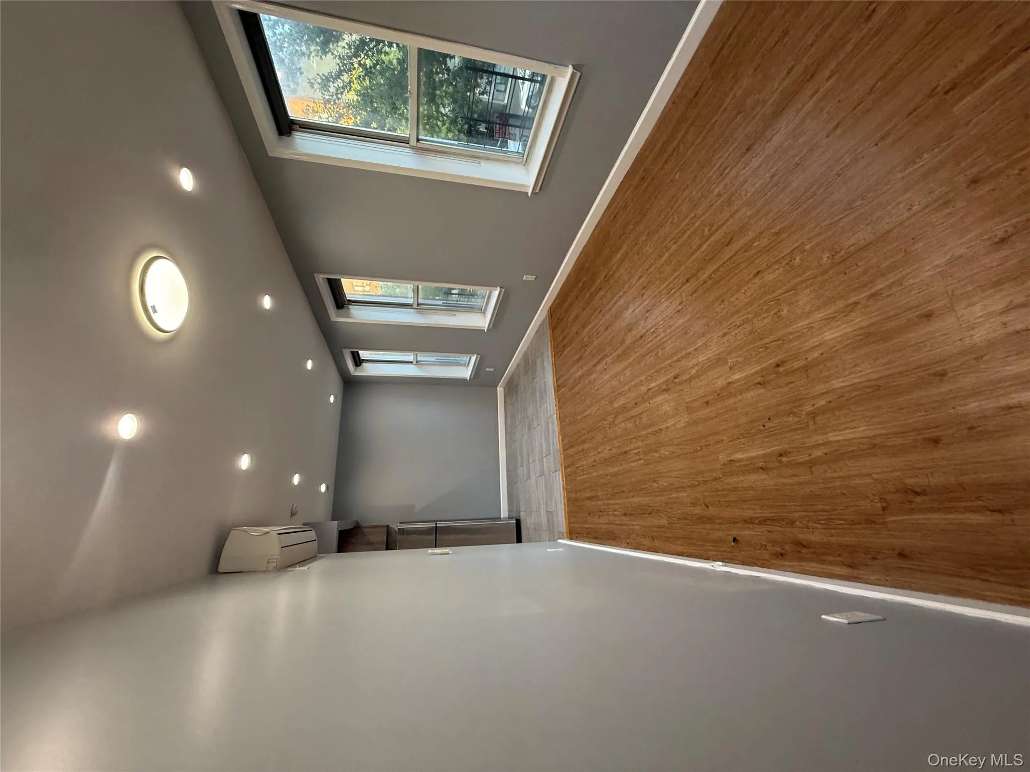 Spare room featuring light wood-type flooring, recessed lighting, and an AC wall unit Spare room featuring light wood-type flooring, recessed lighting, and an AC wall unit