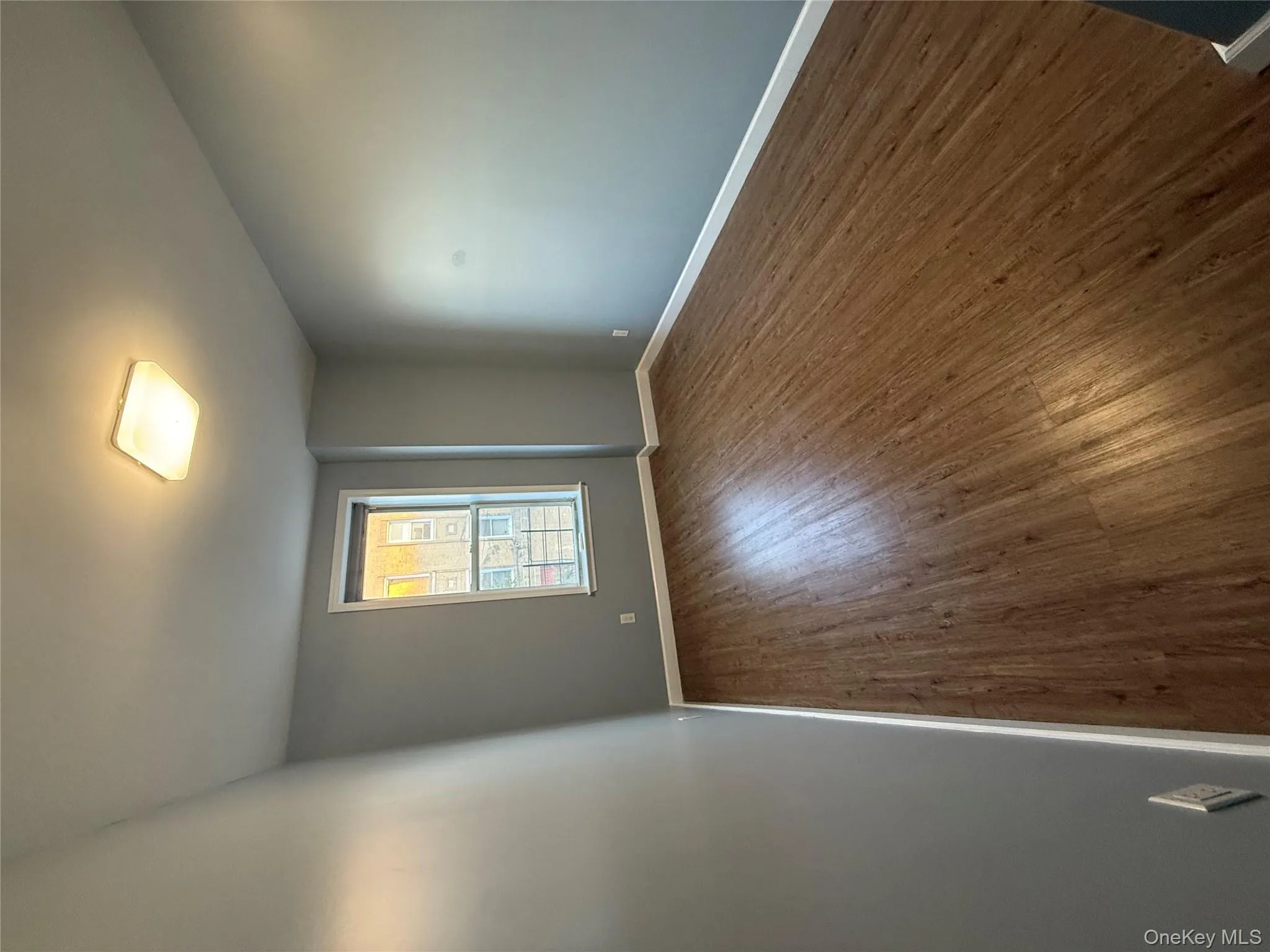 Unfurnished room featuring dark wood-style floors and baseboards Unfurnished room featuring dark wood-style floors and baseboards