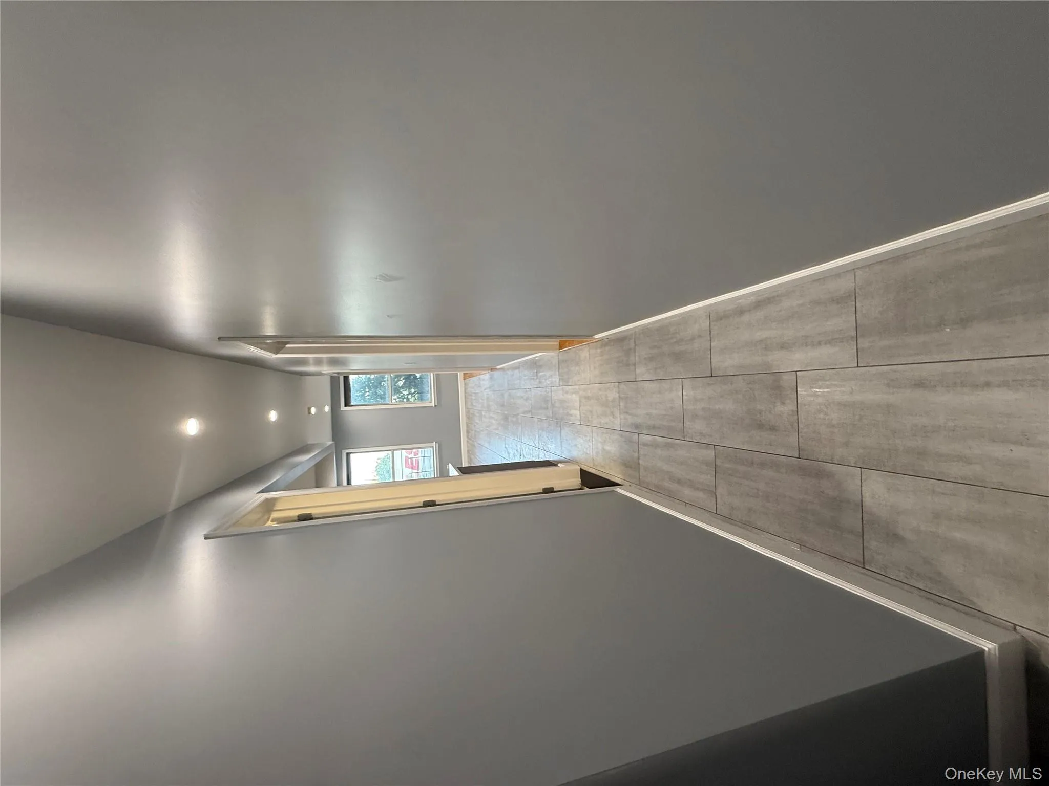 Hallway with recessed lighting and light wood-style flooring Hallway with recessed lighting and light wood-style flooring