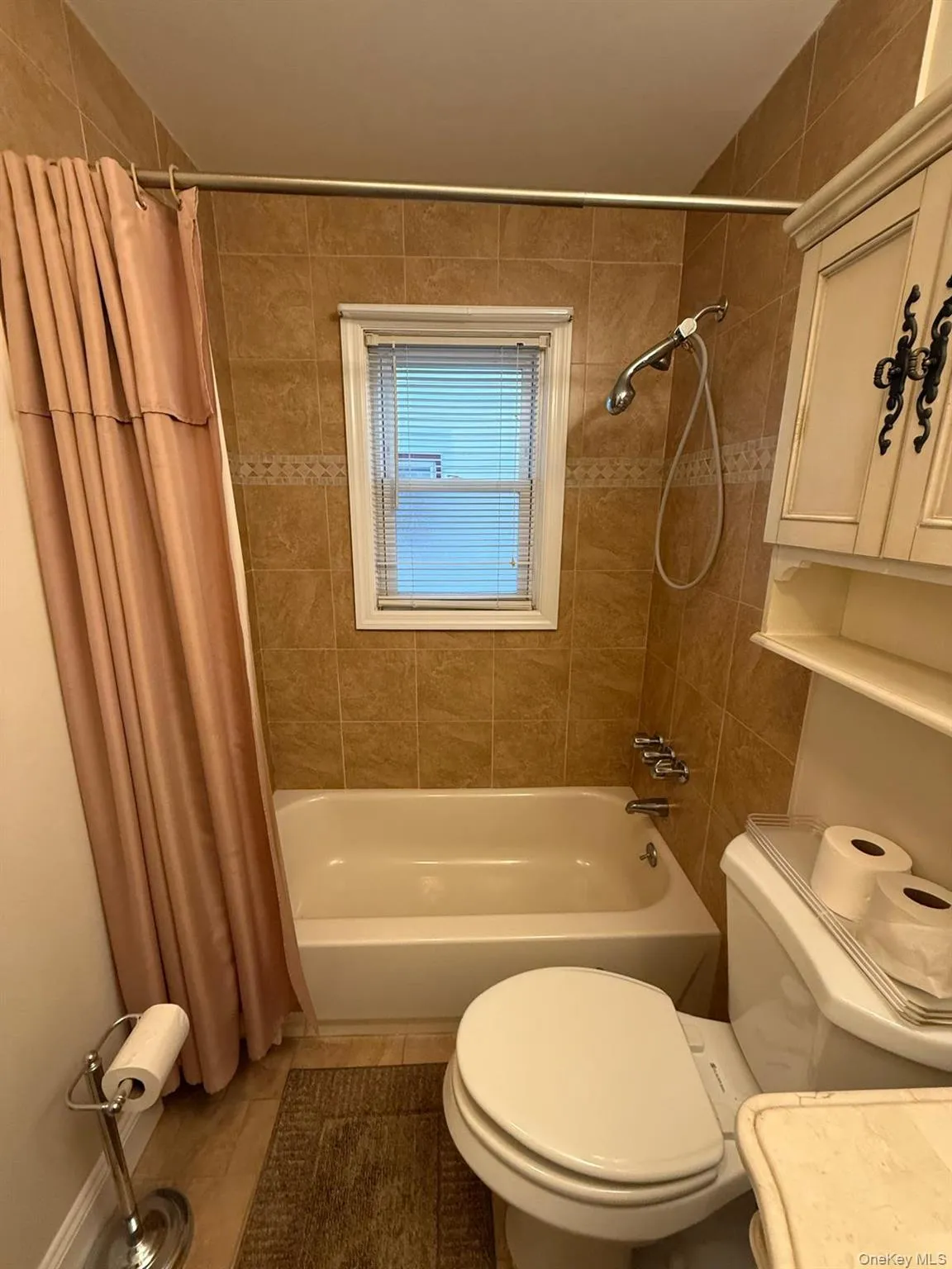 Full bath with shower / tub combo, vanity, and tile patterned floors Full bath with shower / tub combo, vanity, and tile patterned floors