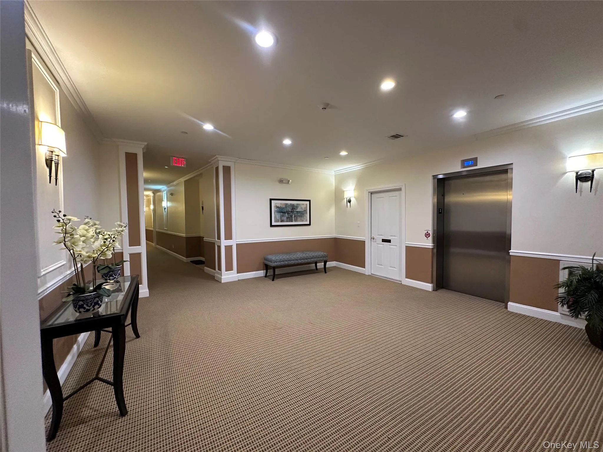 Building lobby with recessed lighting and crown molding Building lobby with recessed lighting and crown molding