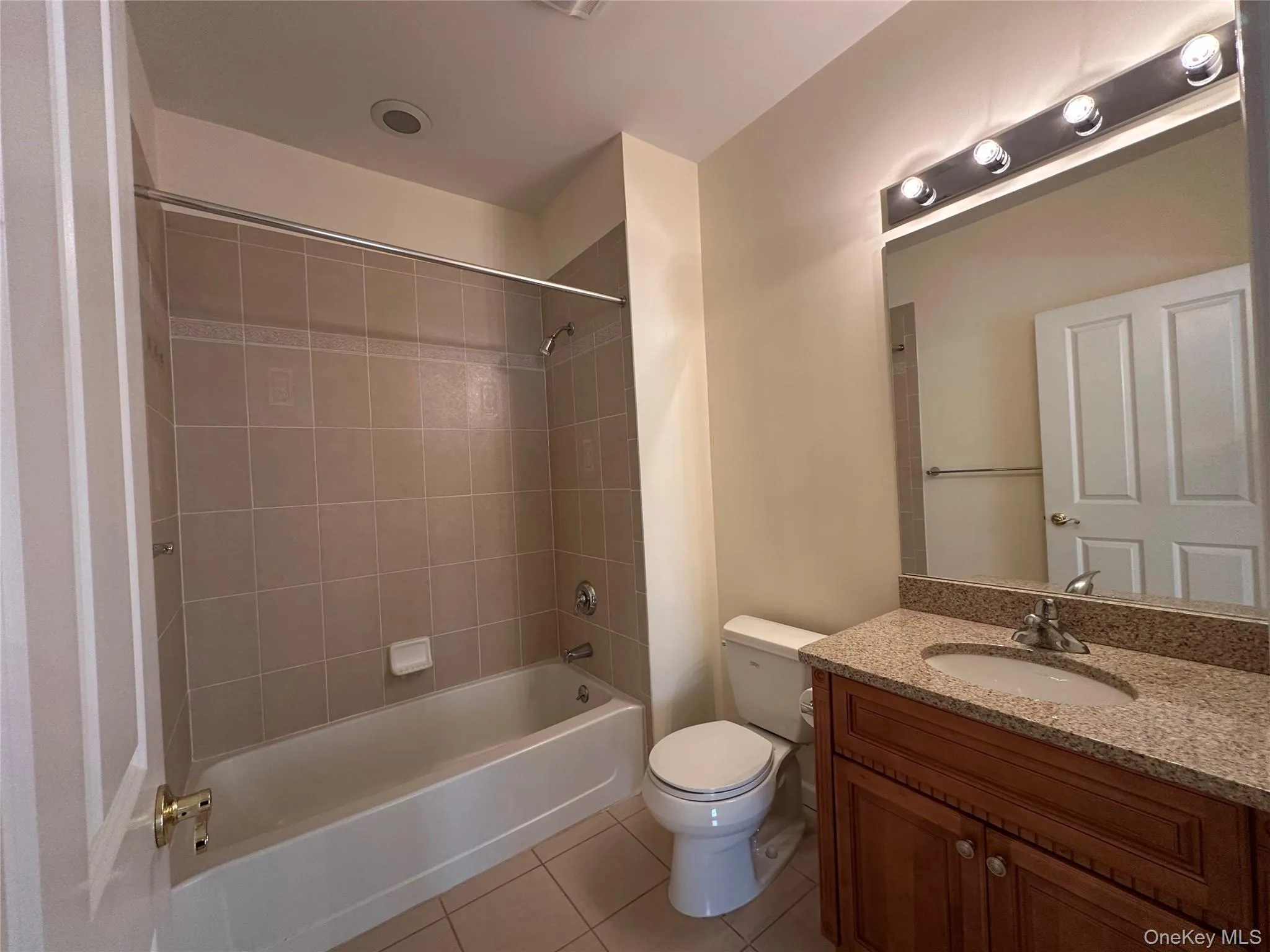 Full bathroom with light tile patterned floors, shower / tub combination, and vanity Full bathroom with light tile patterned floors, shower / tub combination, and vanity