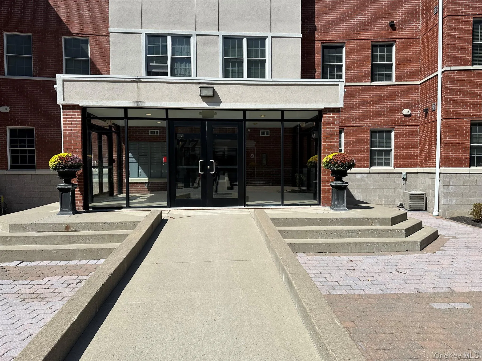 Doorway to property featuring a sunroom, french doors, and stucco siding Doorway to property featuring a sunroom, french doors, and stucco siding