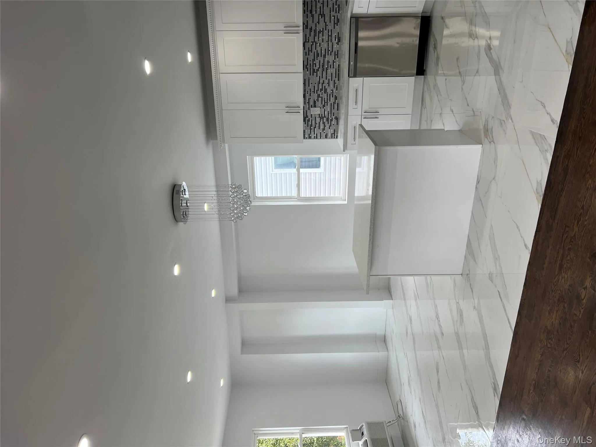 Kitchen featuring recessed lighting, tasteful backsplash, light marble finish floors, and healthy amount of natural light Kitchen featuring recessed lighting, tasteful backsplash, light marble finish floors, and healthy amount of natural light
