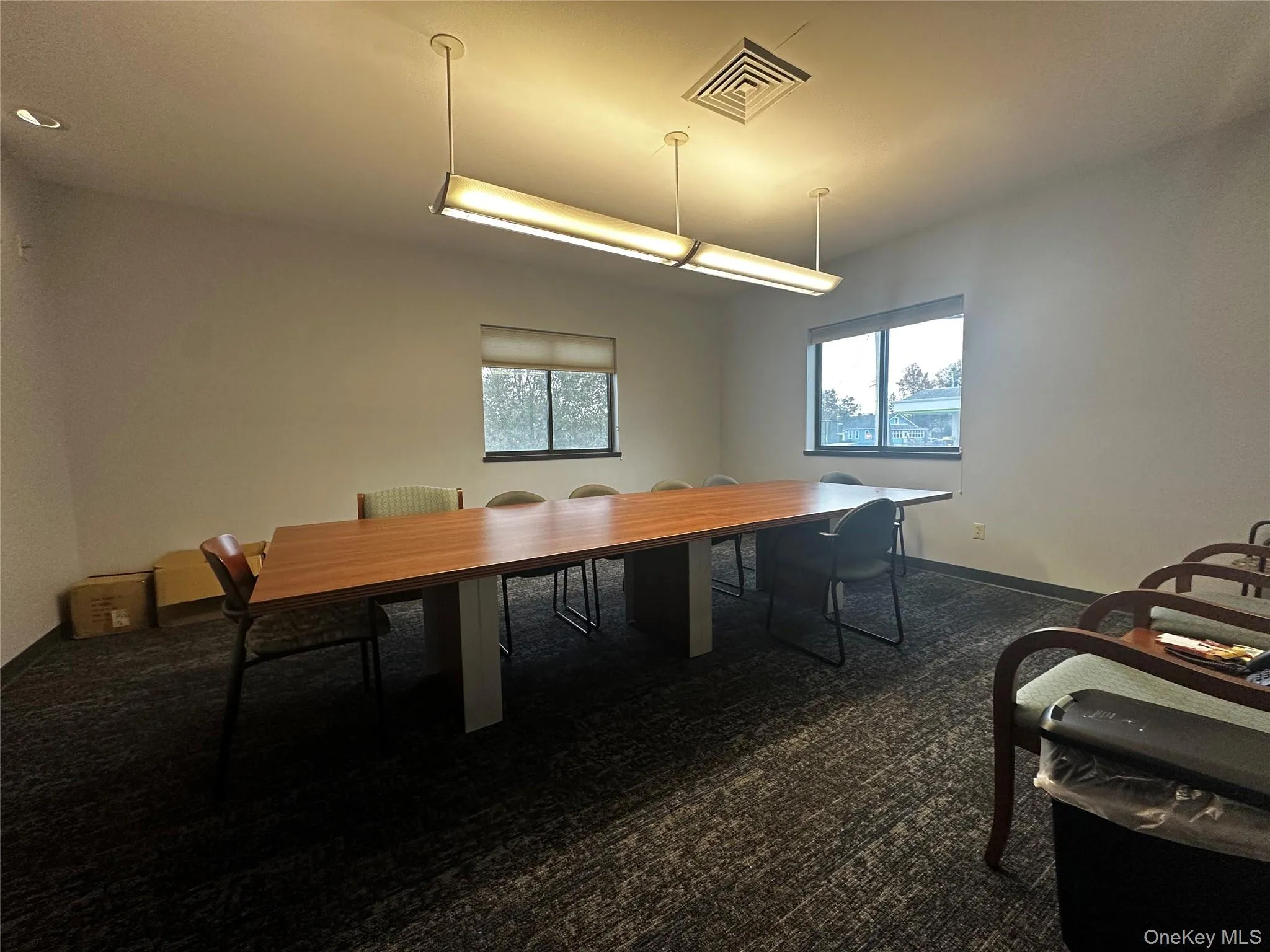 Dining space with dark carpet and baseboards Dining space with dark carpet and baseboards
