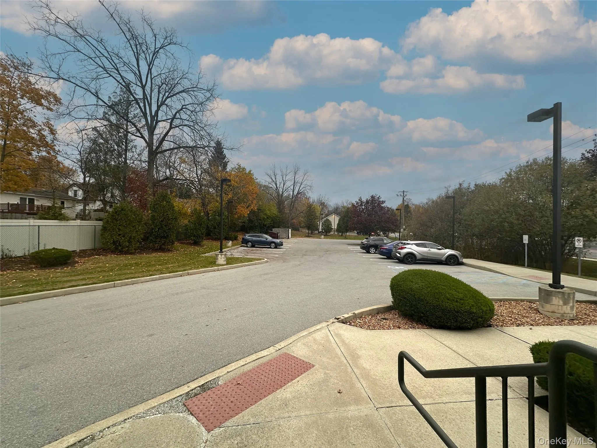 View of asphalt street with curbs and street lights View of asphalt street with curbs and street lights