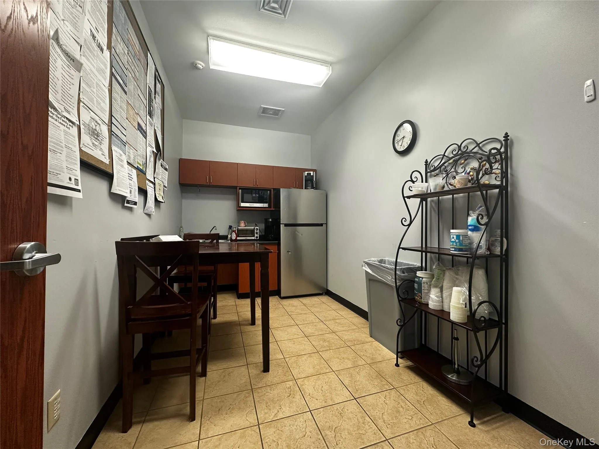 Kitchen with freestanding refrigerator, light tile patterned floors, and built in microwave Kitchen with freestanding refrigerator, light tile patterned floors, and built in microwave