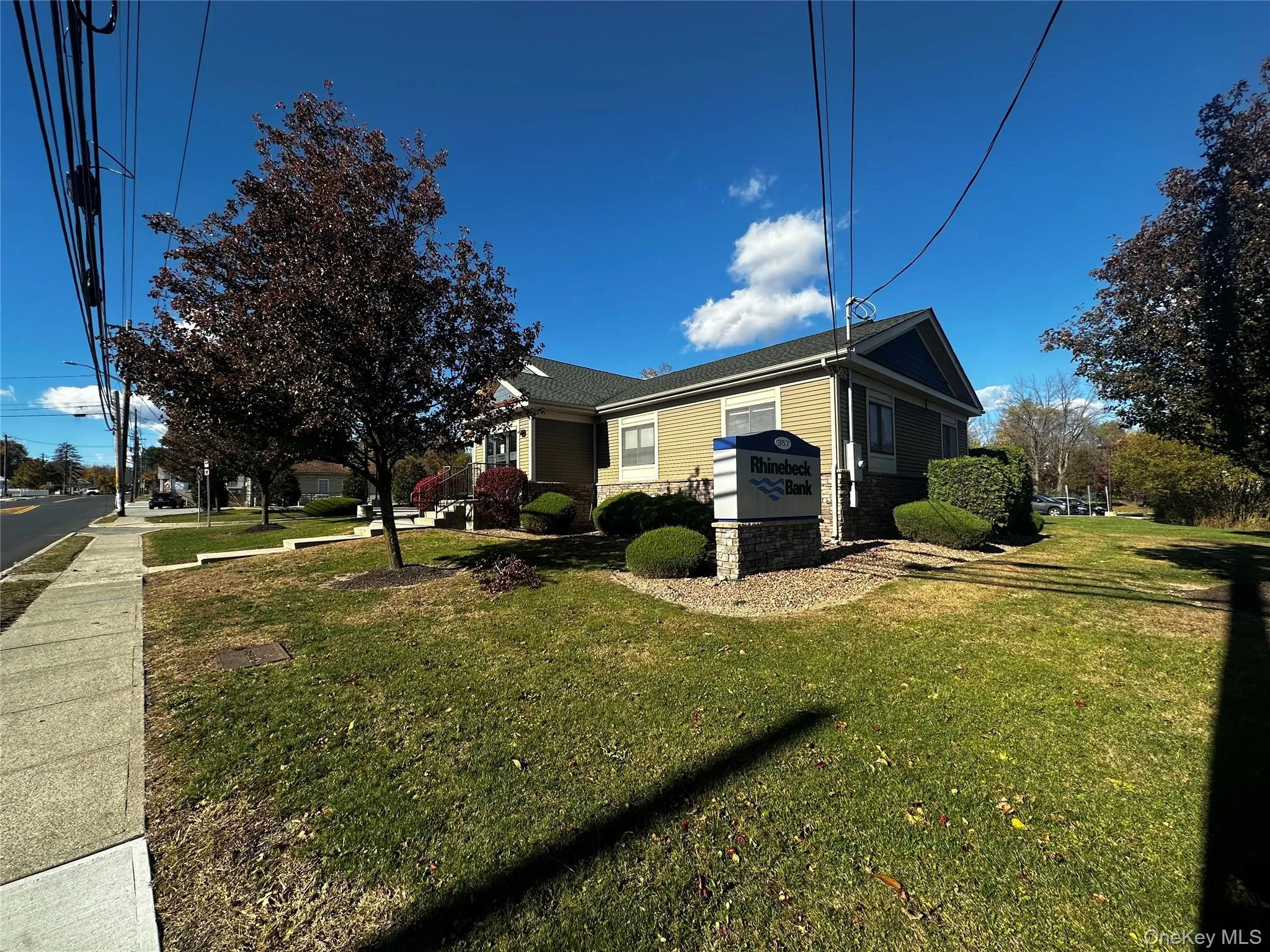 View of home's exterior featuring a yard and stone siding View of home's exterior featuring a yard and stone siding