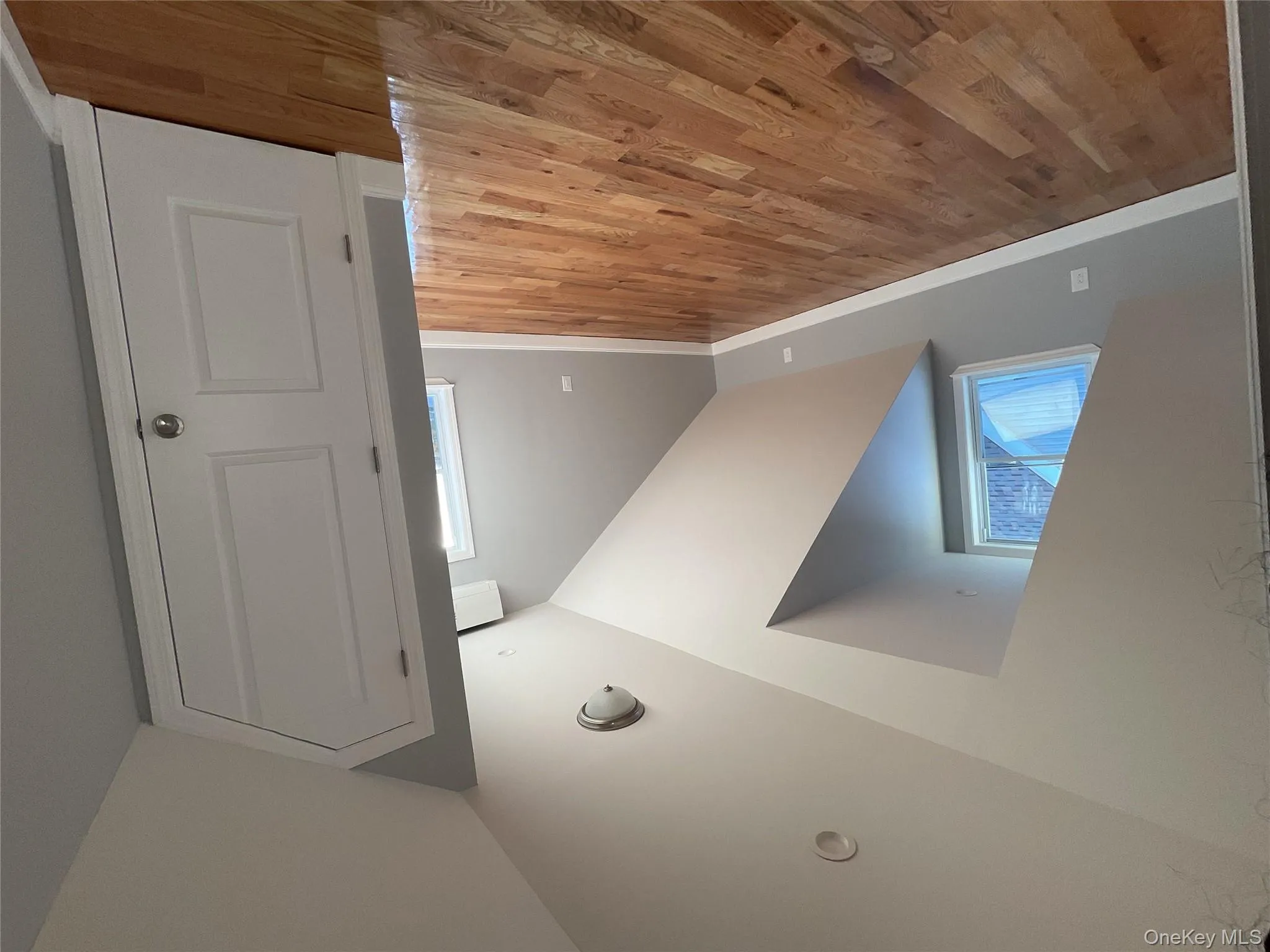 Bonus room featuring vaulted ceiling and light wood finished floors Bonus room featuring vaulted ceiling and light wood finished floors