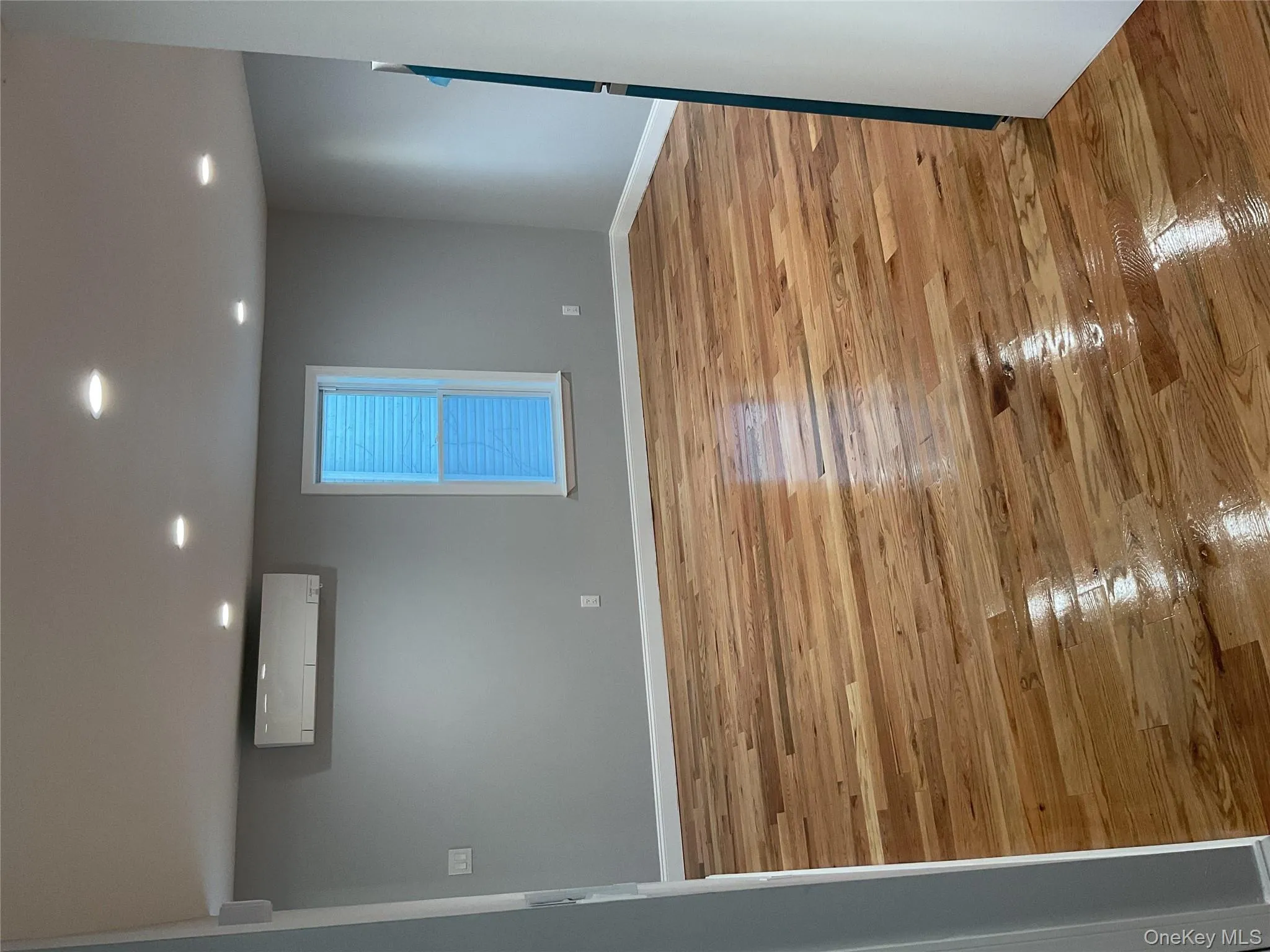 Unfurnished room with light wood-style floors, recessed lighting, and a wall unit AC Unfurnished room with light wood-style floors, recessed lighting, and a wall unit AC