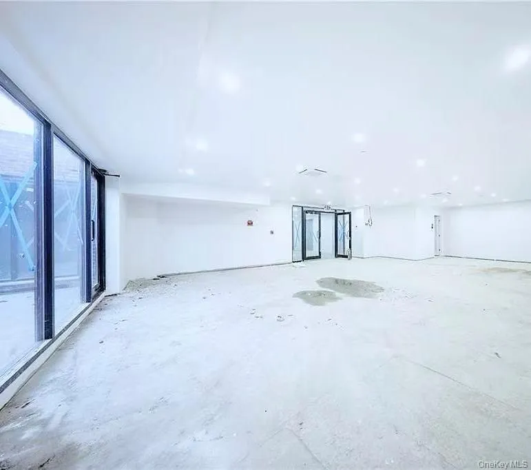 Unfurnished room featuring unfinished concrete floors Unfurnished room featuring unfinished concrete floors