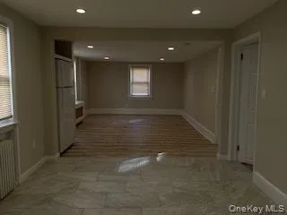 Empty room with recessed lighting and radiator Empty room with recessed lighting and radiator