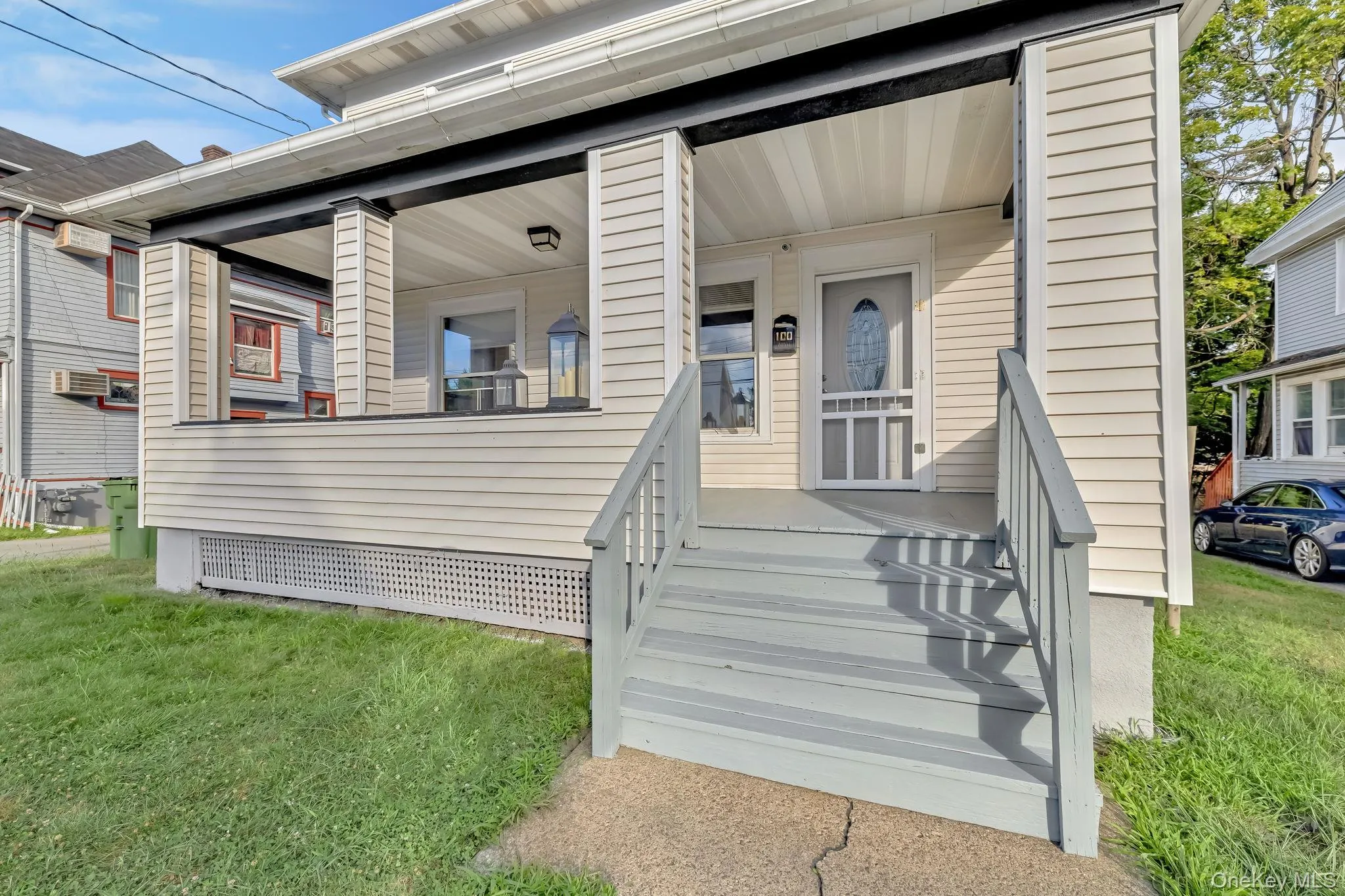 Entrance to property with a lawn and covered porch Entrance to property with a lawn and covered porch