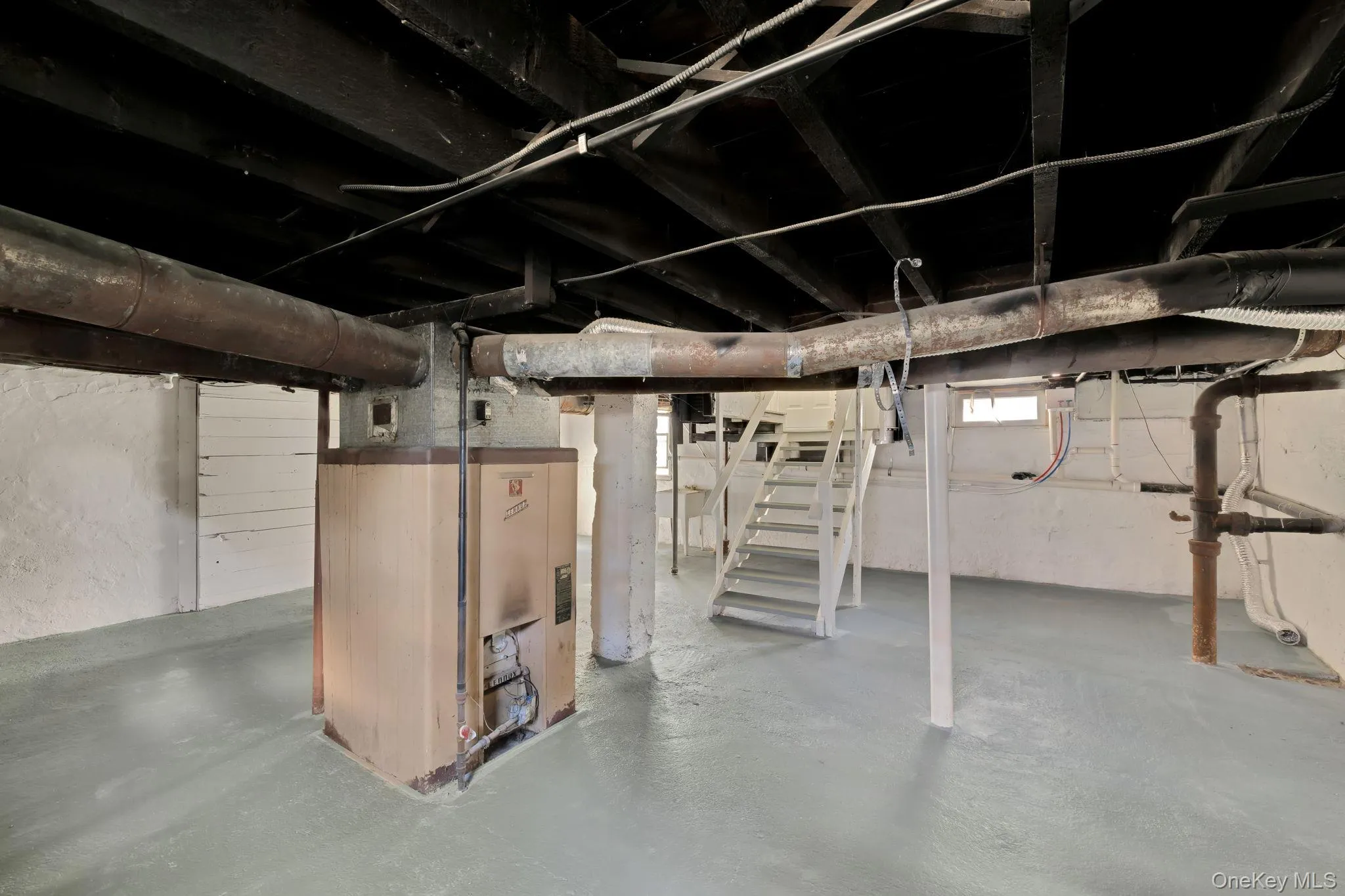 Basement with stairs and heating unit Basement with stairs and heating unit