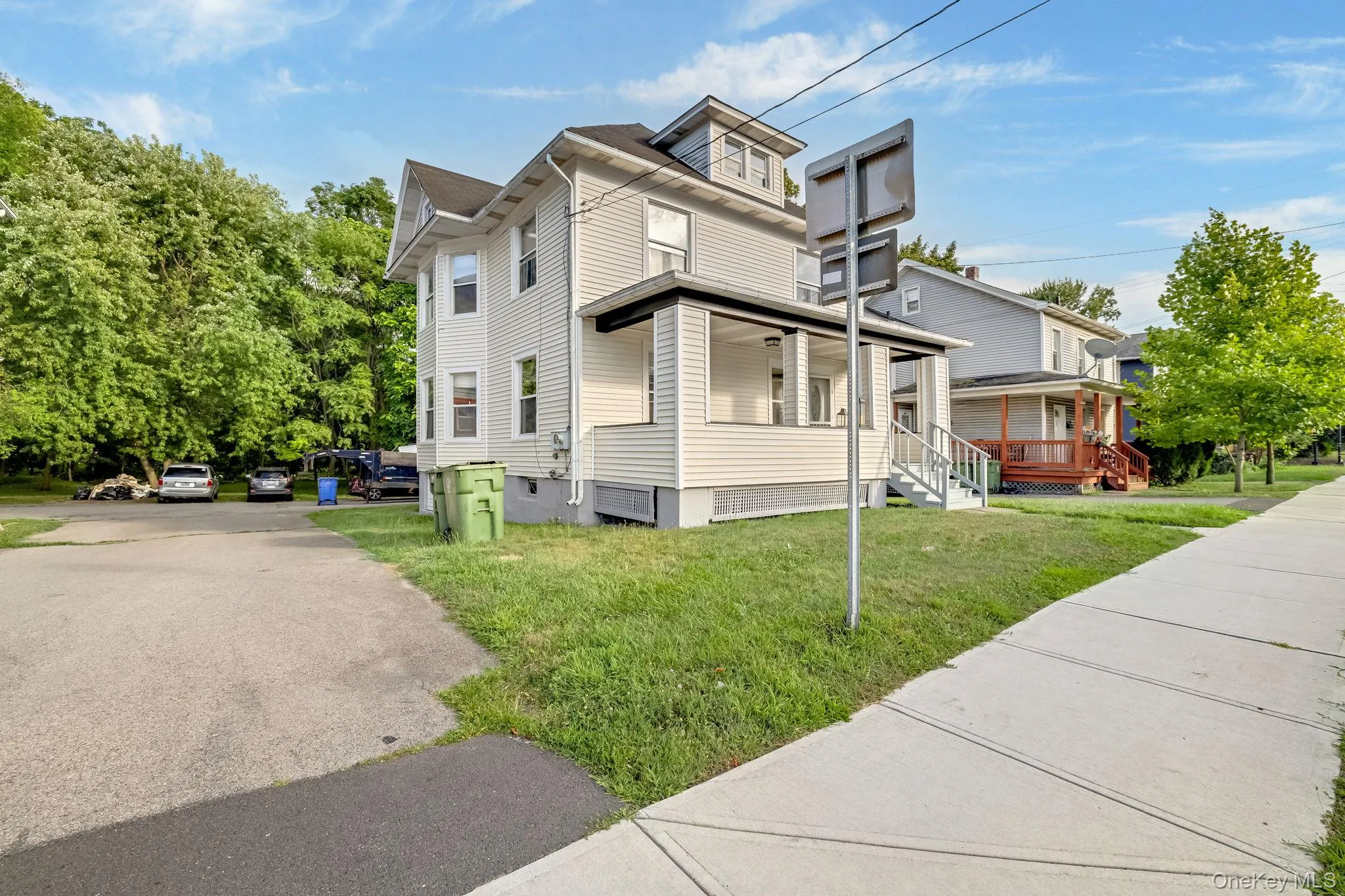 View of front of property featuring covered porch and a front lawn View of front of property featuring covered porch and a front lawn