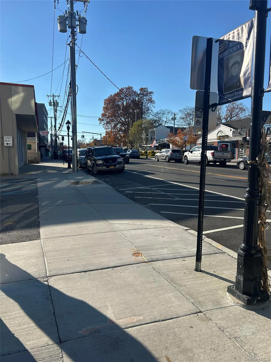 View of asphalt street with sidewalks and curbs View of asphalt street with sidewalks and curbs