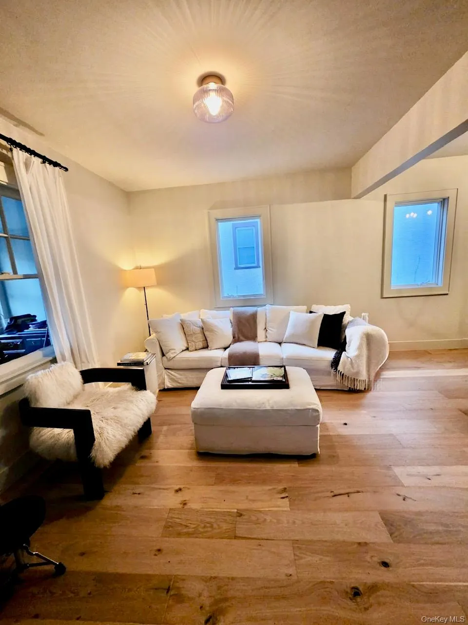 Living room with hardwood / wood-style flooring and baseboards Living room with hardwood / wood-style flooring and baseboards