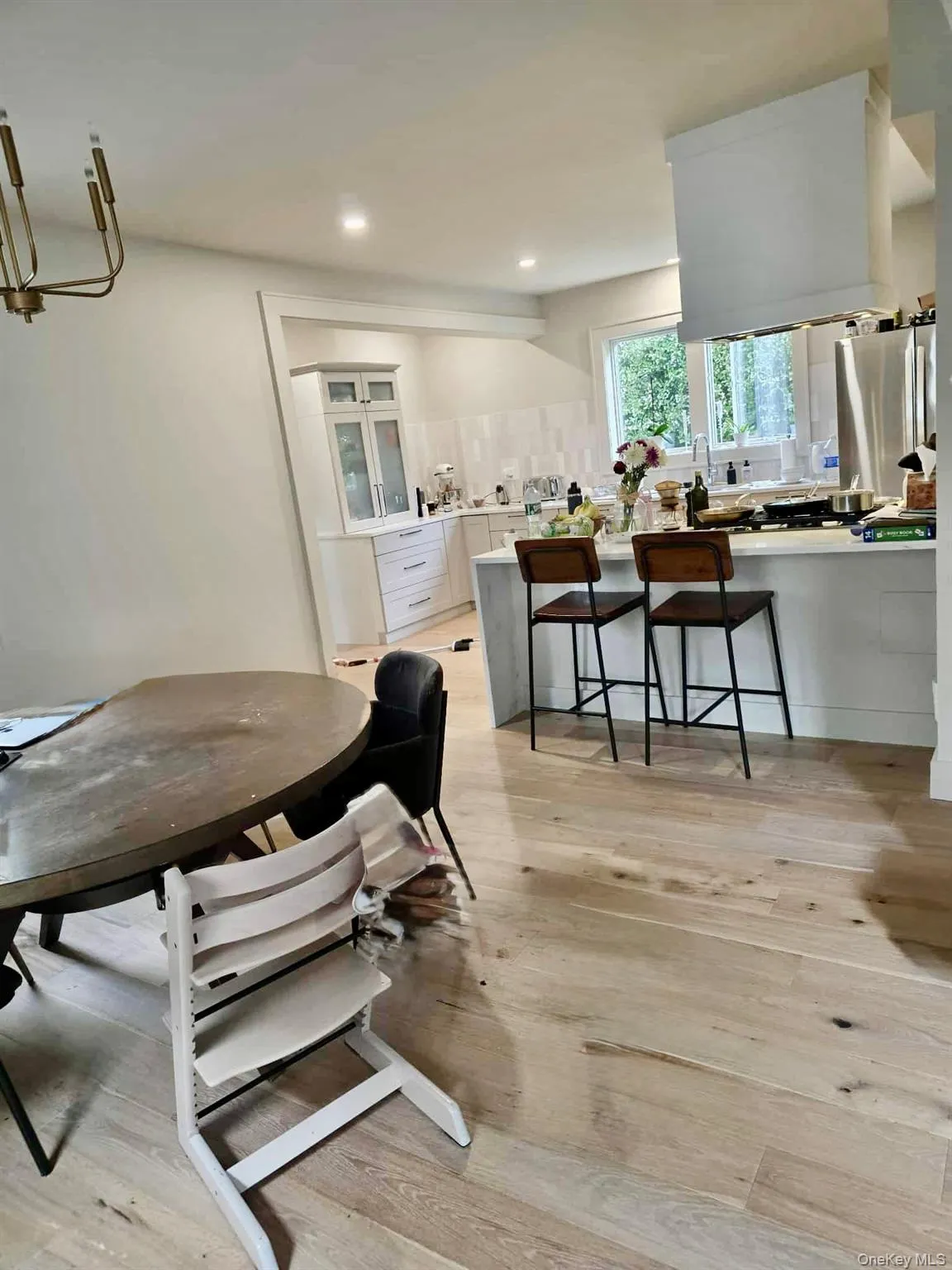 Dining area with light wood-style floors and recessed lighting Dining area with light wood-style floors and recessed lighting