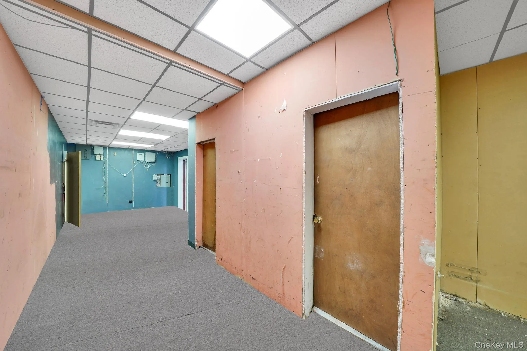 Corridor with carpet and a drop ceiling Corridor with carpet and a drop ceiling