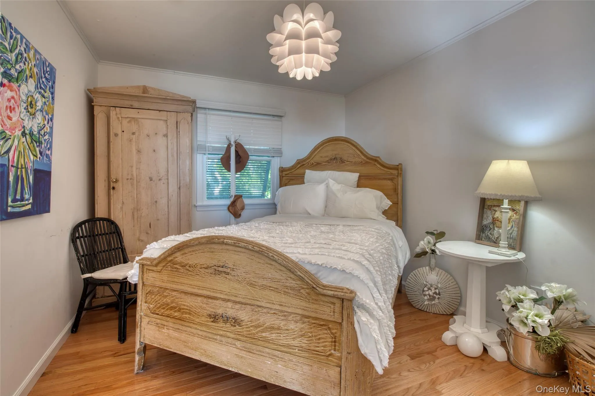 Bedroom with crown molding and wood finished floors Bedroom with crown molding and wood finished floors