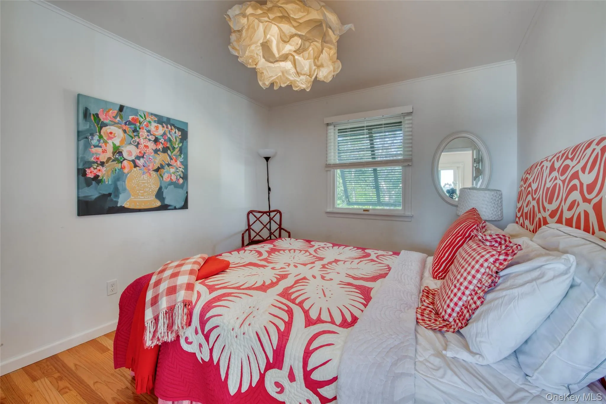 Bedroom with wood finished floors and crown molding Bedroom with wood finished floors and crown molding