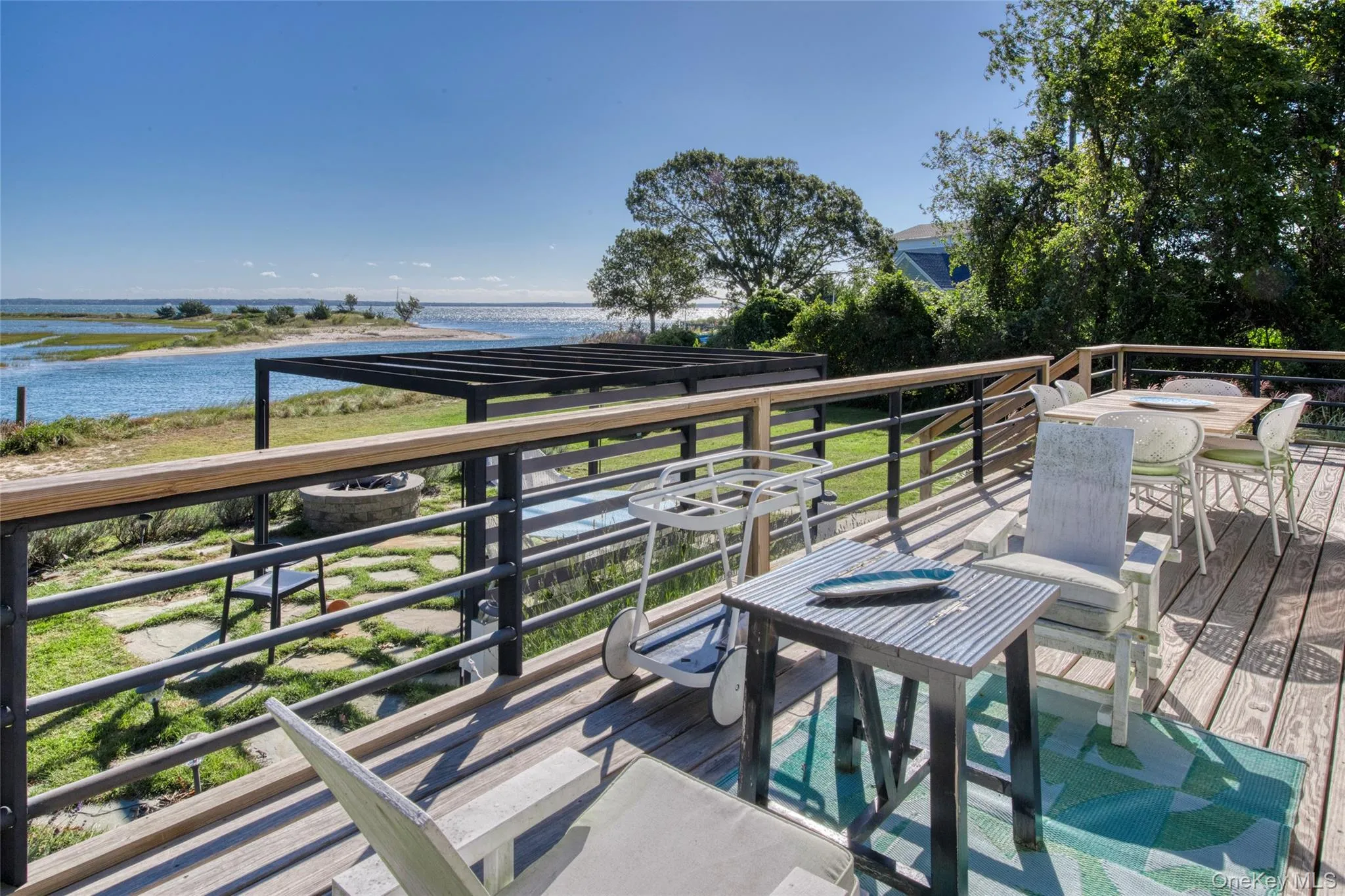 Deck featuring a water view and outdoor dining space Deck featuring a water view and outdoor dining space
