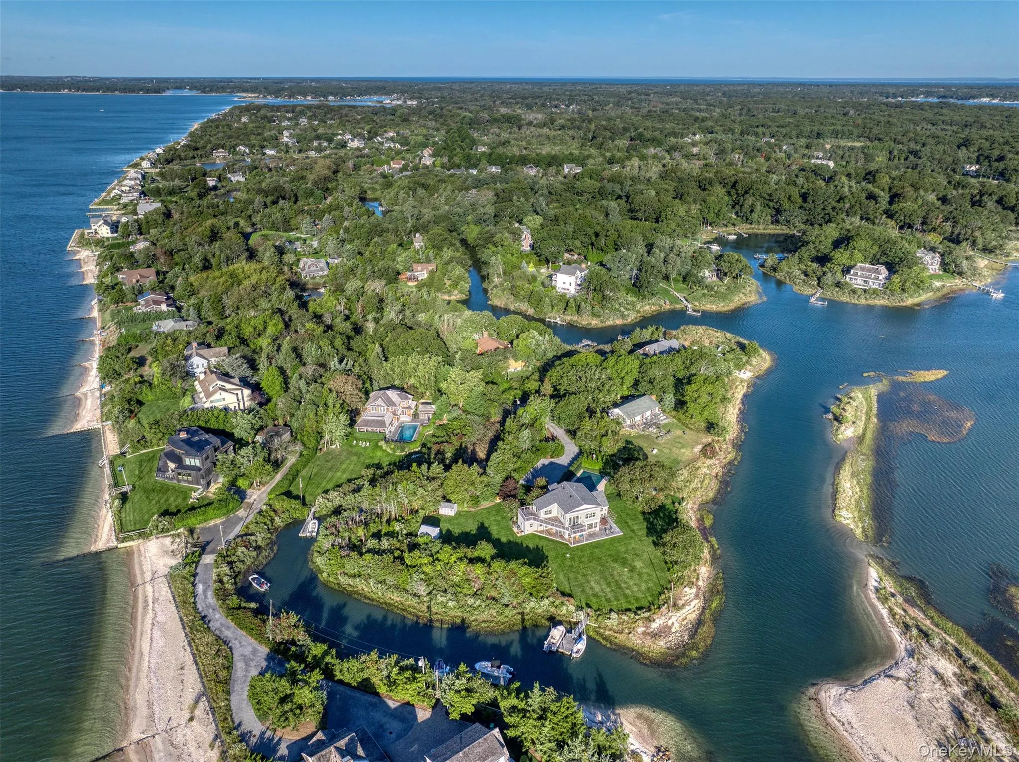 Aerial view of property's location featuring a large body of water Aerial view of property's location featuring a large body of water