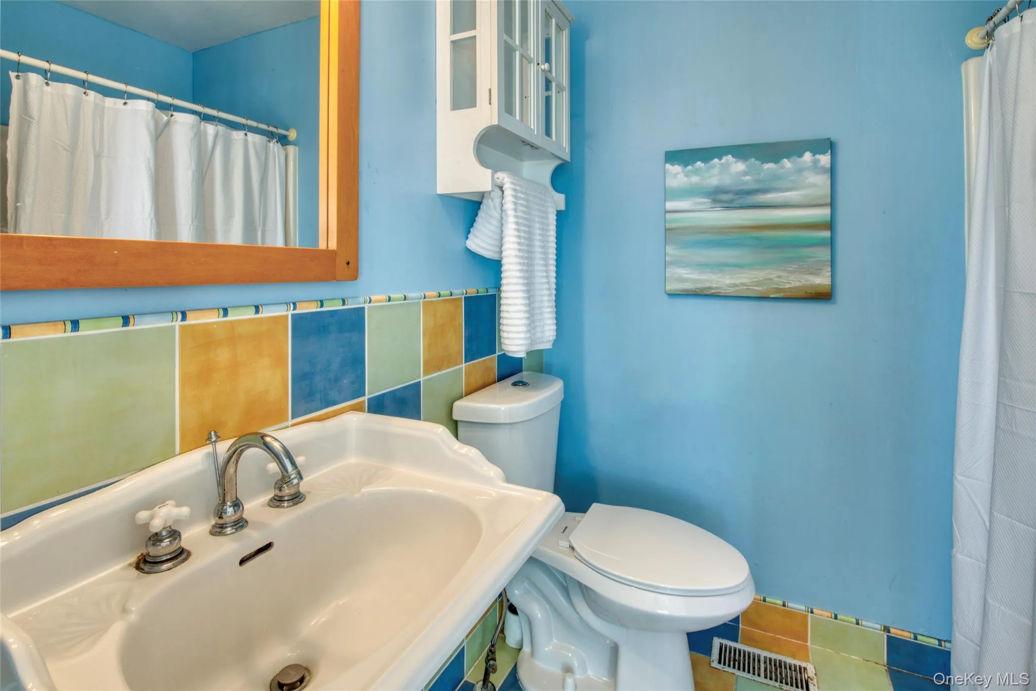 Full bath featuring curtained shower and tile patterned floors Full bath featuring curtained shower and tile patterned floors