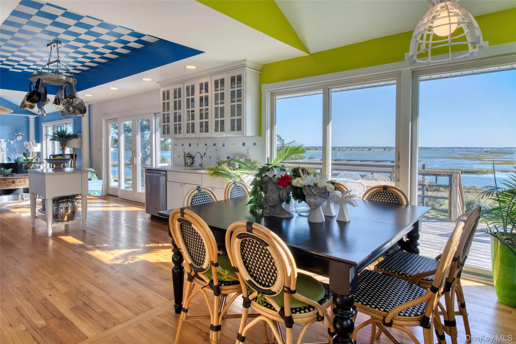 Dining space with a chandelier, light wood-type flooring, a water view, and recessed lighting Dining space with a chandelier, light wood-type flooring, a water view, and recessed lighting