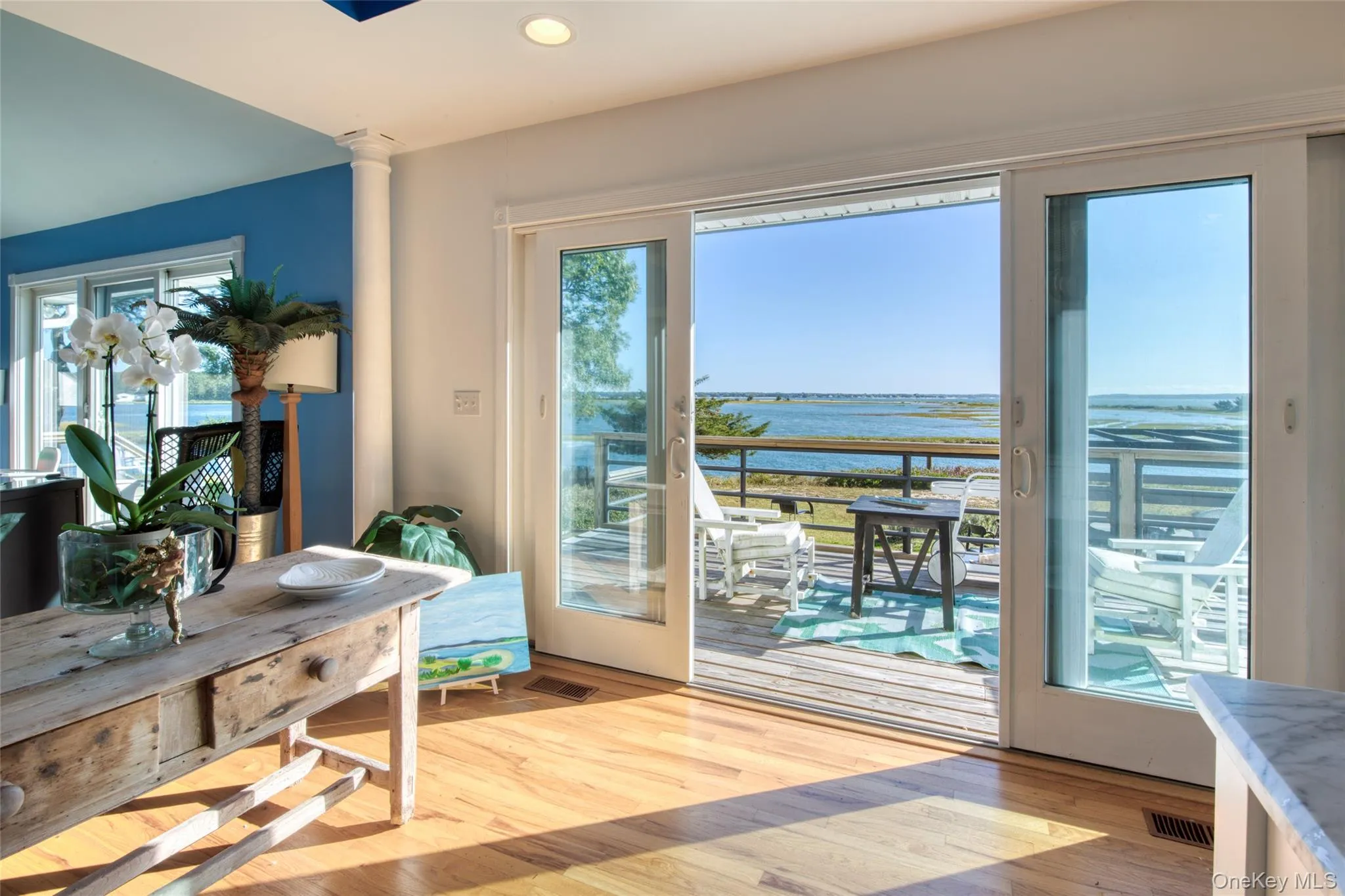 Doorway to outside with wood finished floors, a water view, plenty of natural light, and recessed lighting Doorway to outside with wood finished floors, a water view, plenty of natural light, and recessed lighting