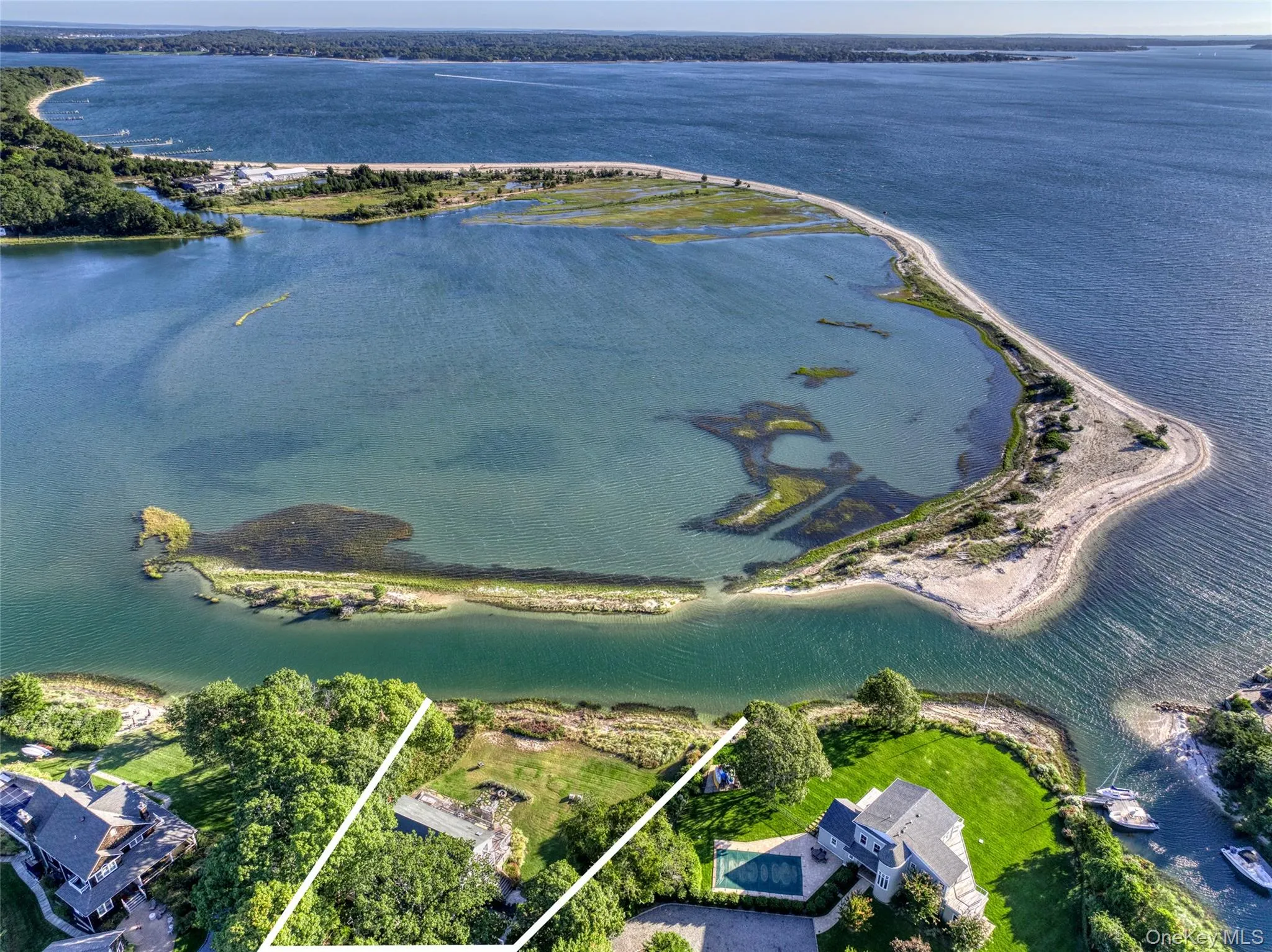 Aerial view of property and surrounding area featuring a large body of water and property parcel outlined Aerial view of property and surrounding area featuring a large body of water and property parcel outlined