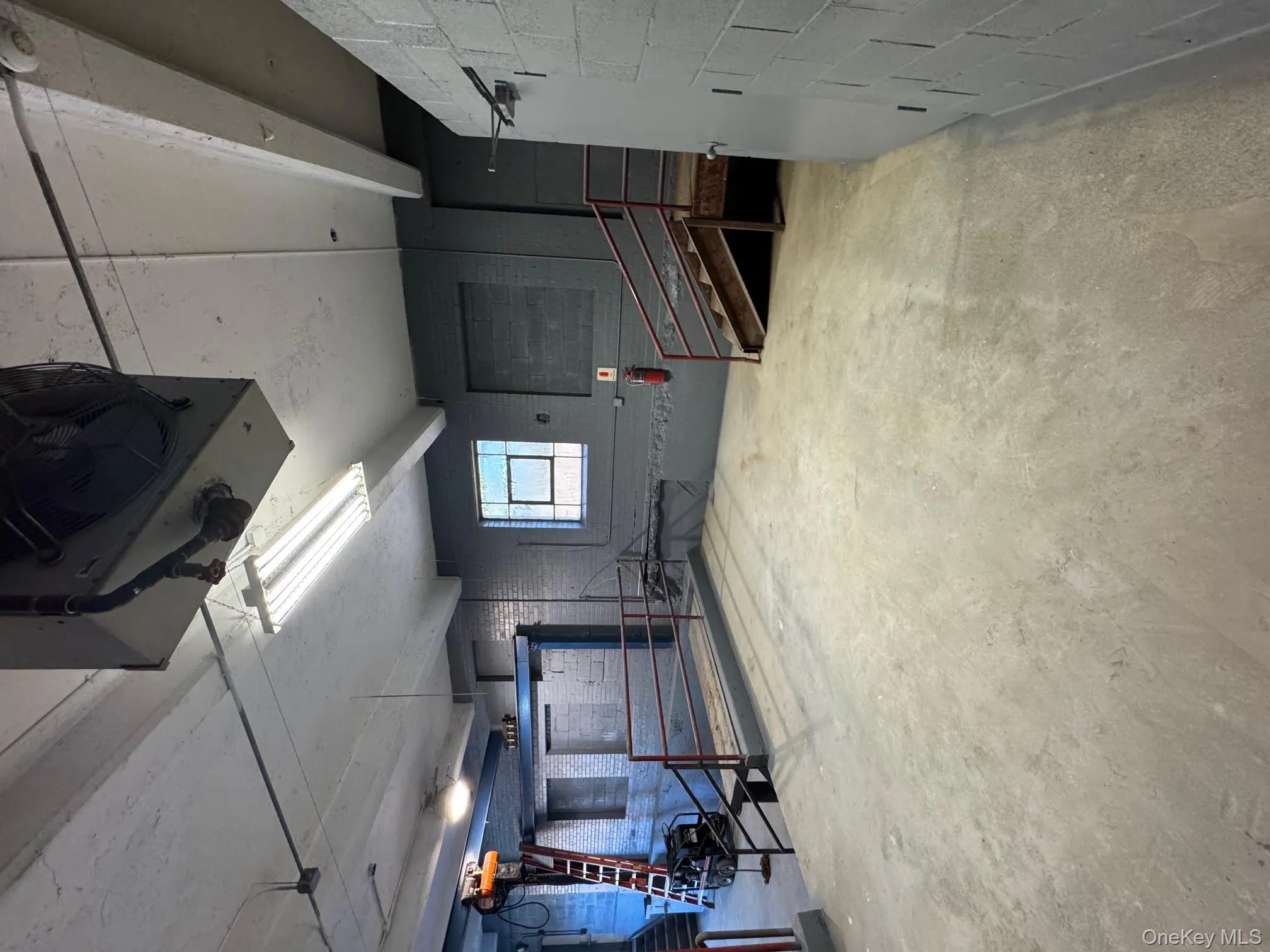 Below grade area featuring concrete block wall and a heating unit Below grade area featuring concrete block wall and a heating unit