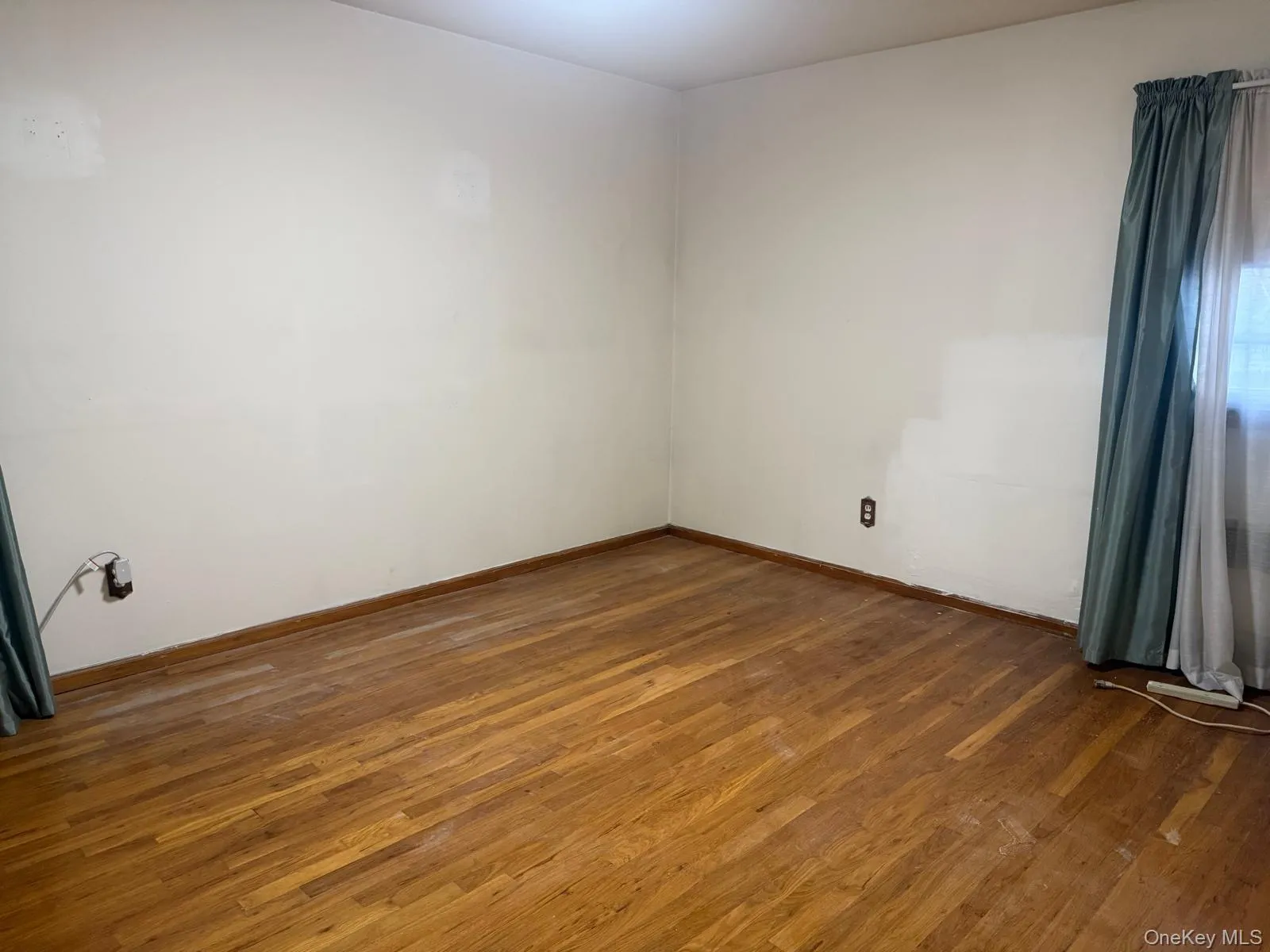 Empty room with dark wood finished floors Empty room with dark wood finished floors