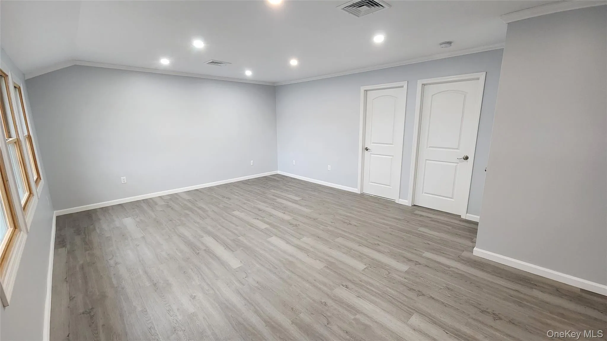 Spare room with recessed lighting, light wood-style flooring, and ornamental molding Spare room with recessed lighting, light wood-style flooring, and ornamental molding