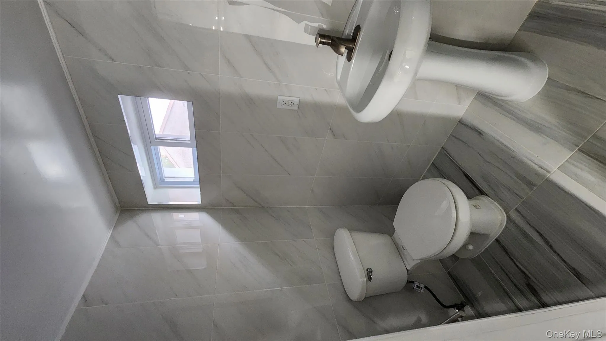 Bathroom with tile walls and toilet Bathroom with tile walls and toilet