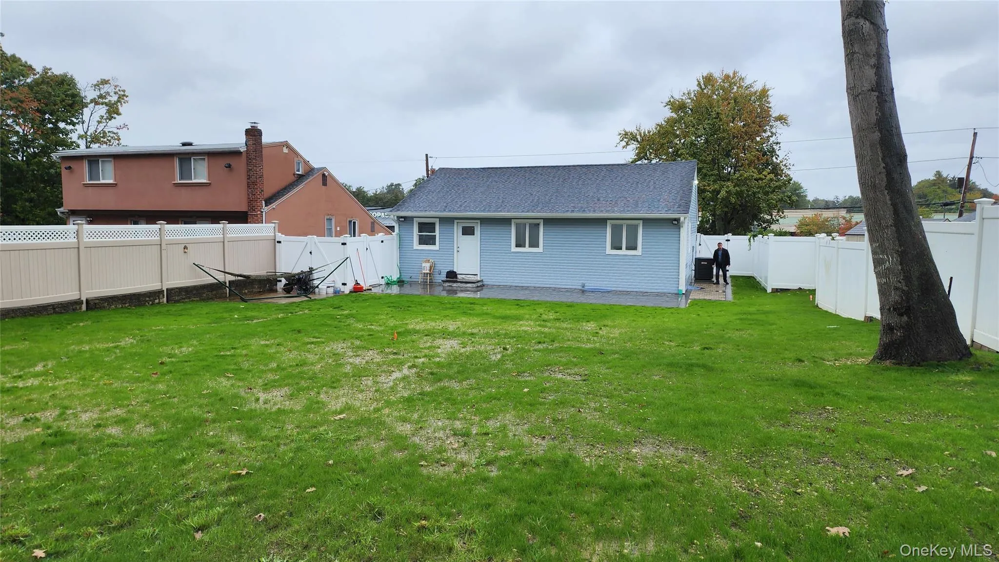 Back of house with a fenced backyard, a gate, and a patio area Back of house with a fenced backyard, a gate, and a patio area