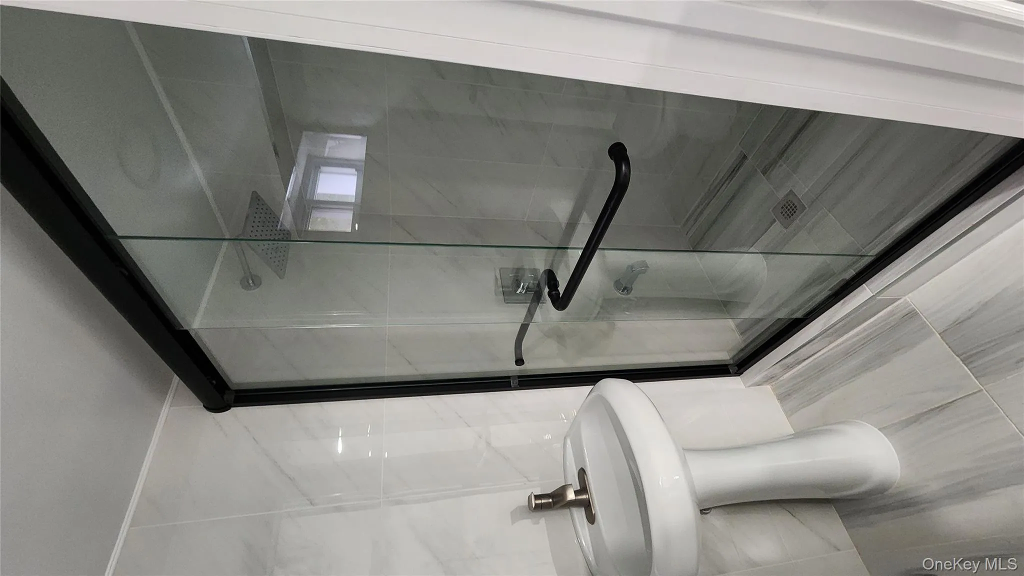 Full bathroom with a shower stall and a sink Full bathroom with a shower stall and a sink