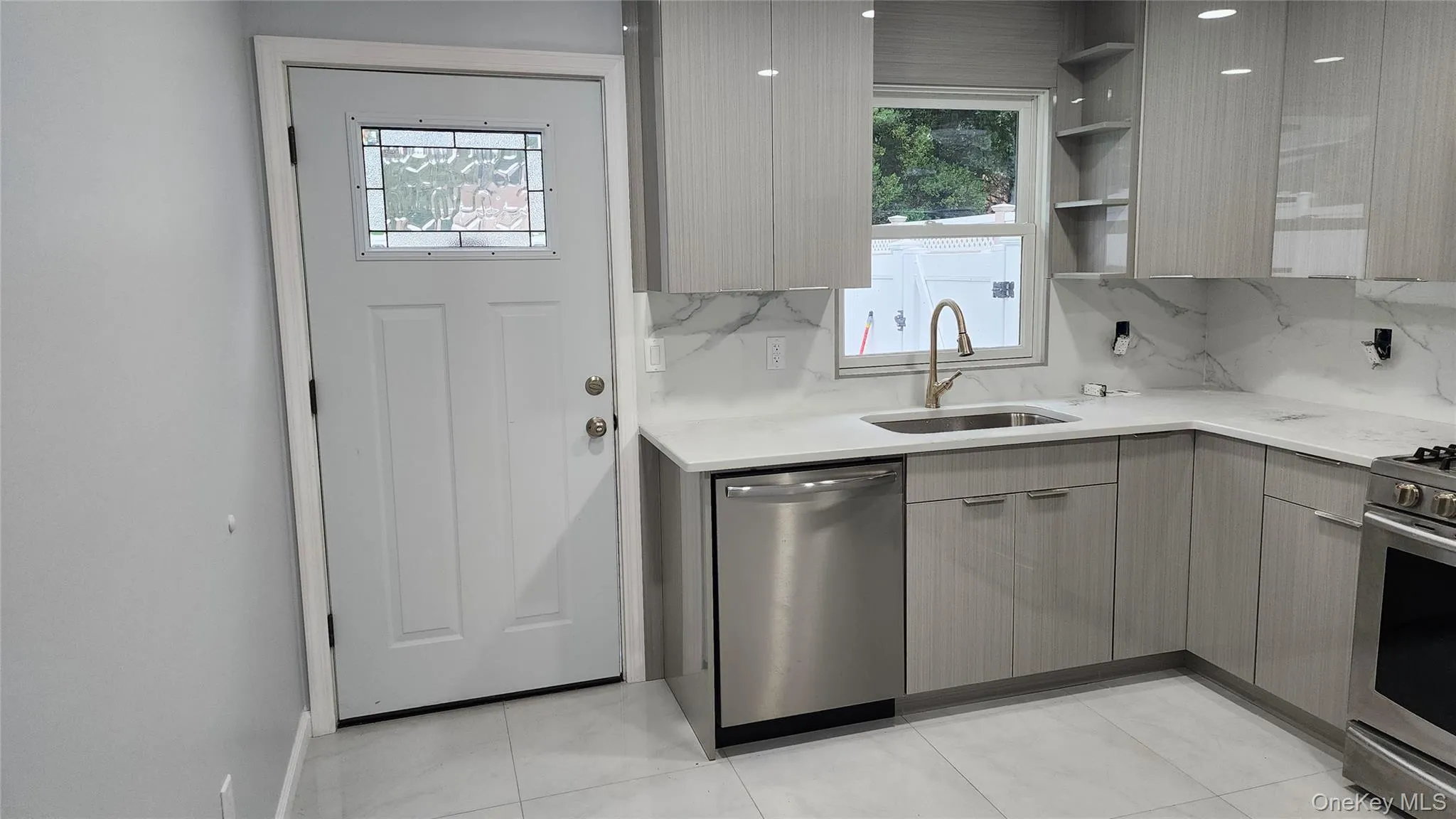 Kitchen featuring plenty of natural light, stainless steel appliances, and modern cabinets Kitchen featuring plenty of natural light, stainless steel appliances, and modern cabinets