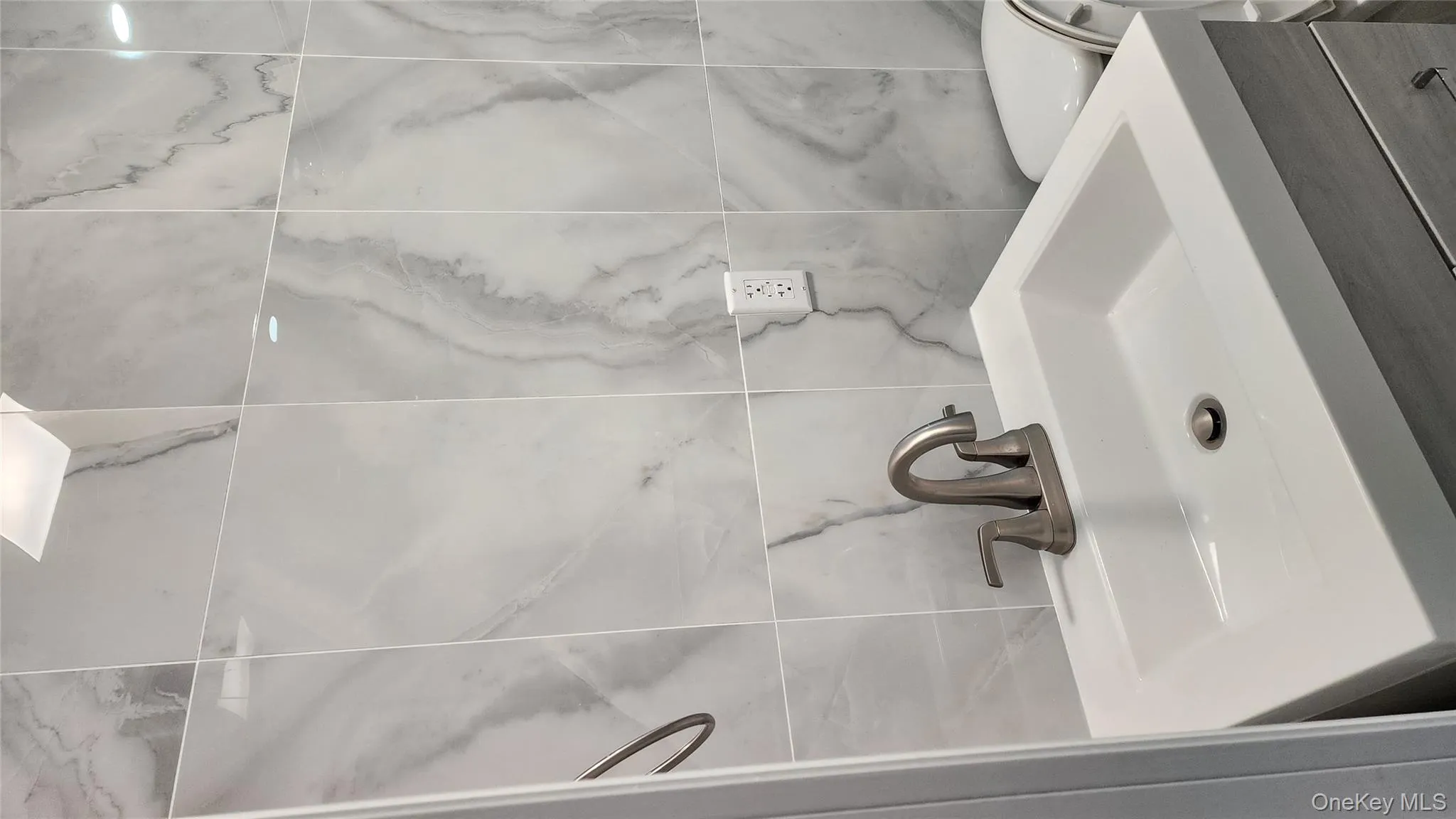 Bathroom featuring vanity and tile walls Bathroom featuring vanity and tile walls