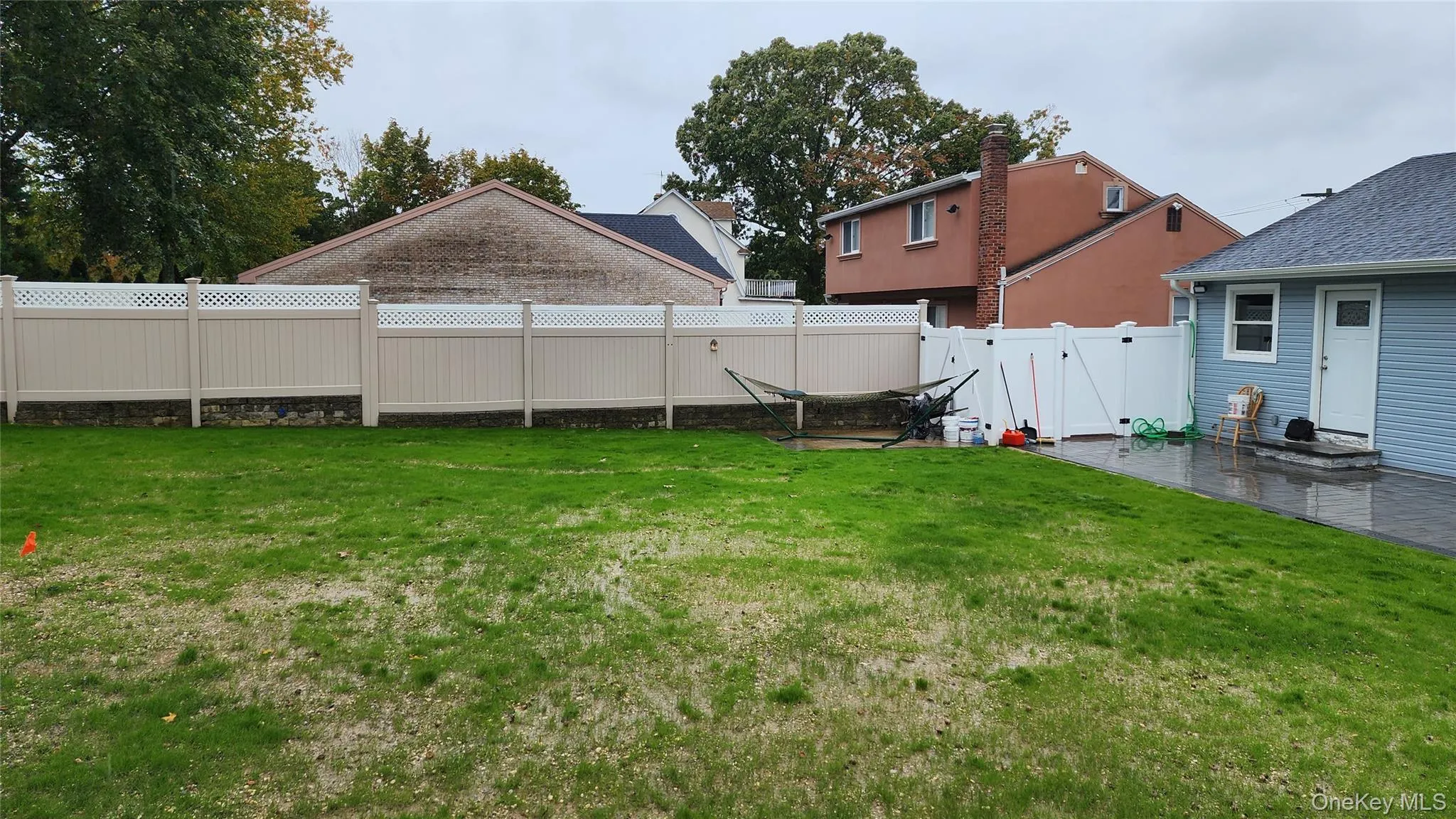 Fenced backyard with a patio area Fenced backyard with a patio area