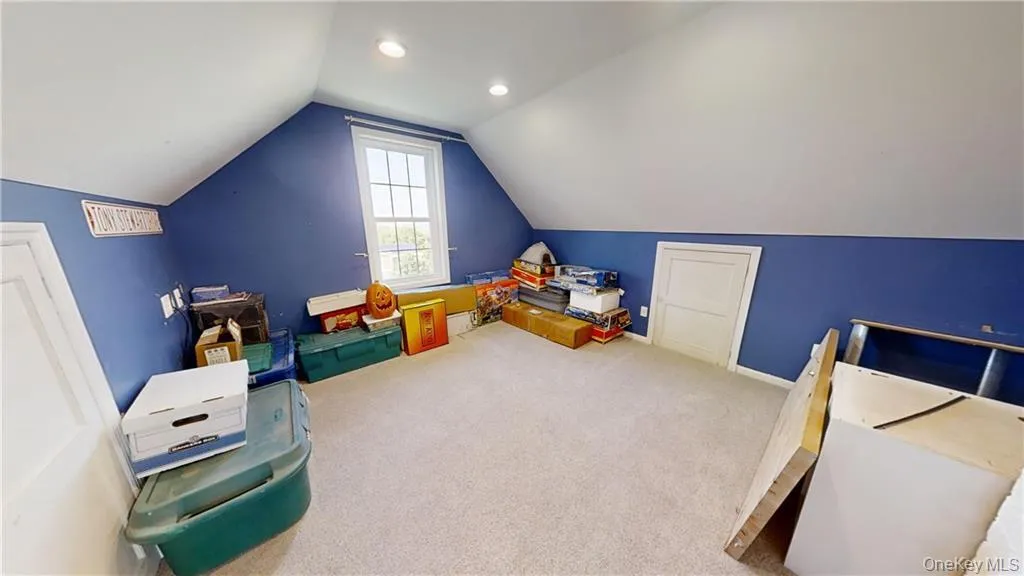 Playroom featuring carpet floors, lofted ceiling, and recessed lighting Playroom featuring carpet floors, lofted ceiling, and recessed lighting